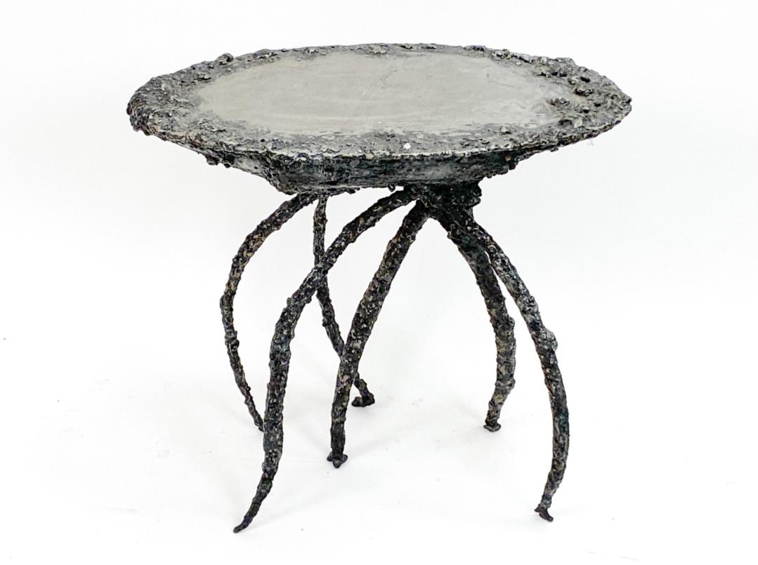 This is a one-of-a-kind, side or occasional table, of torch-cut, welded, textured and enameled steel. Created by American artist, James Bearden, this unique item is a true statement piece. The multi undulating, textured surface is as fun to touch as