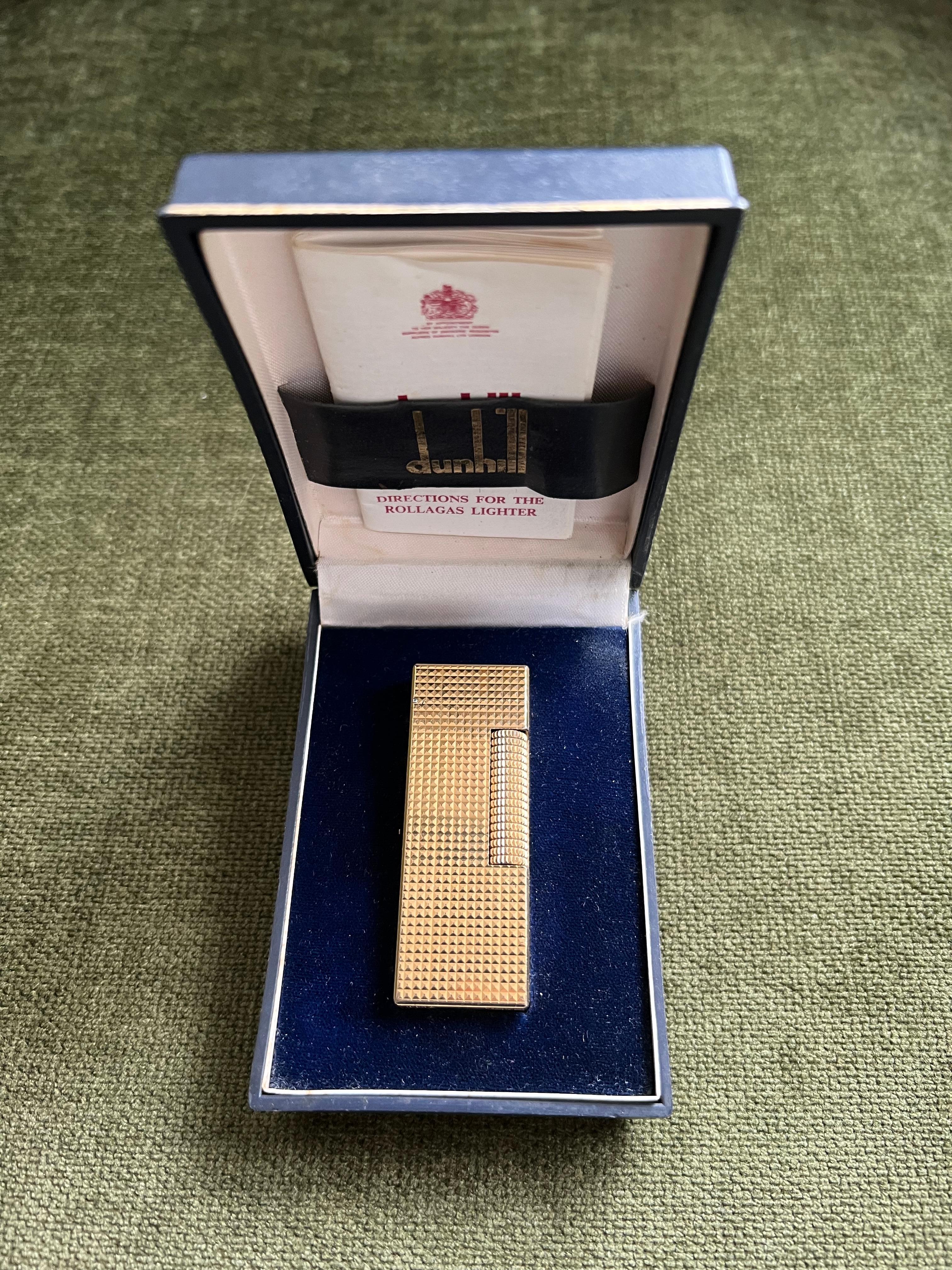 Vintage Dunhill Diamond Pattern Gold Plated Lighter 
Circa 1970
Retro 
In fantastic working condition 
The lighter sparks, ignites and flames 
Built like a tank
All original parts 
Comes with original Dunhill case and papers 