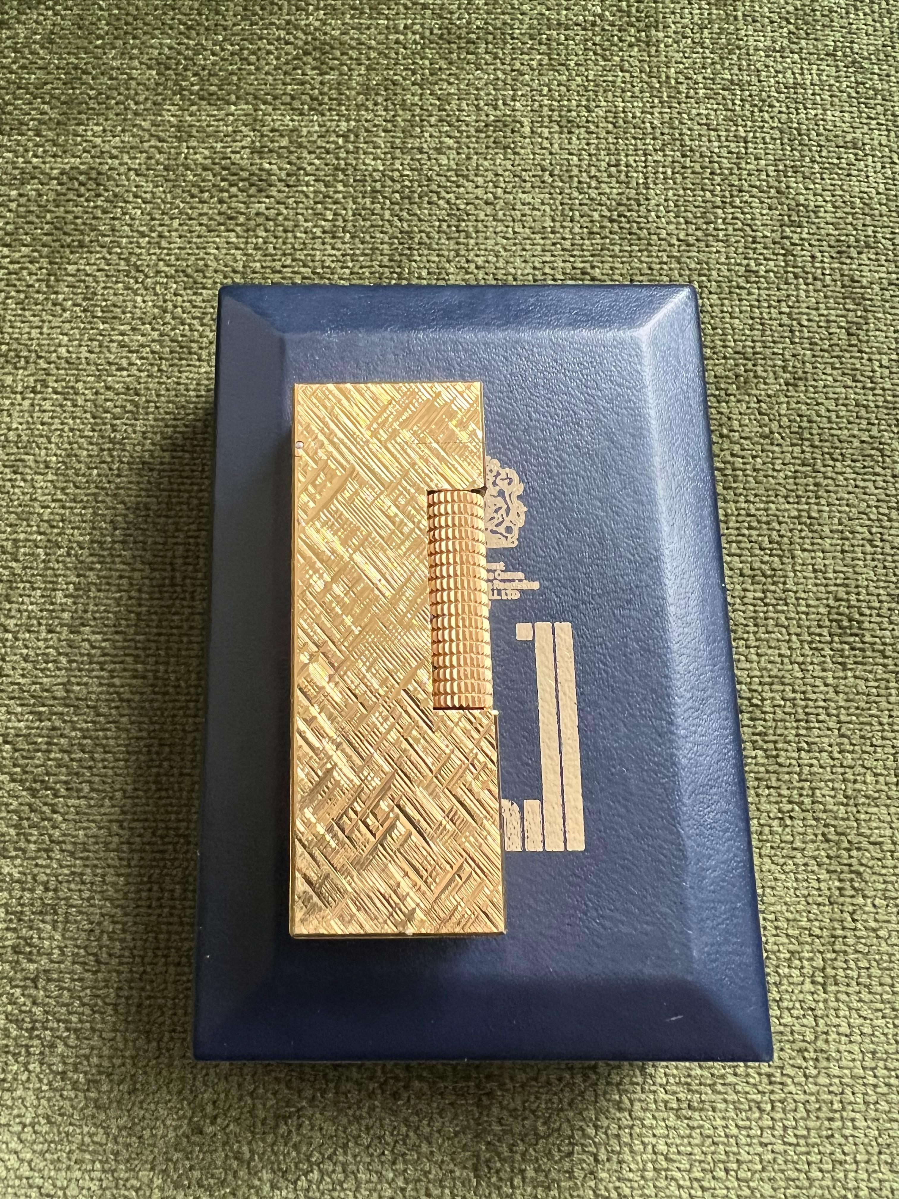 Rare Vintage Dunhill gold plated Swiss Made lighter 
In mint condition.
Art Deco. 
Works perfectly. 
Iconic and beautifully engineered piece rare condition, 
James Bond lighter of choice.
In original box which is Sky blue box.
Original paper