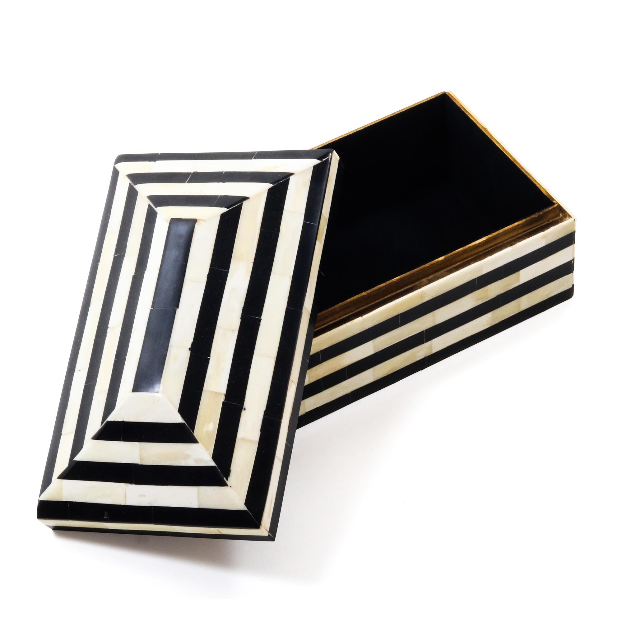 An ivory and black striped decorative resin and bone box.
     