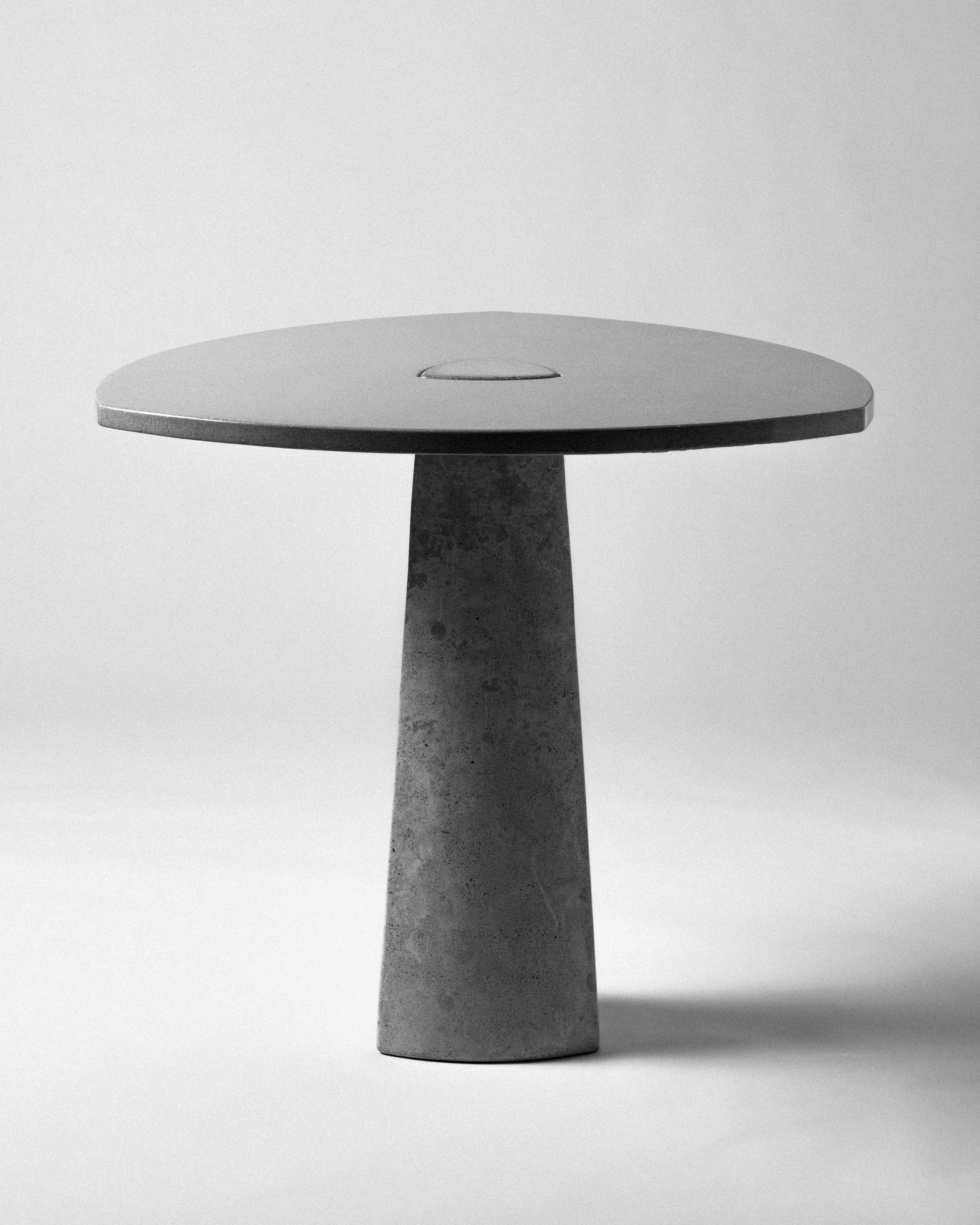 Our favorite breakfast table. The clover table features two pieces of concrete- rounded triangular tabletop and base, locked together by gravity alone. Equal in art and utility, the table serves as a collector's piece and as a functional dining