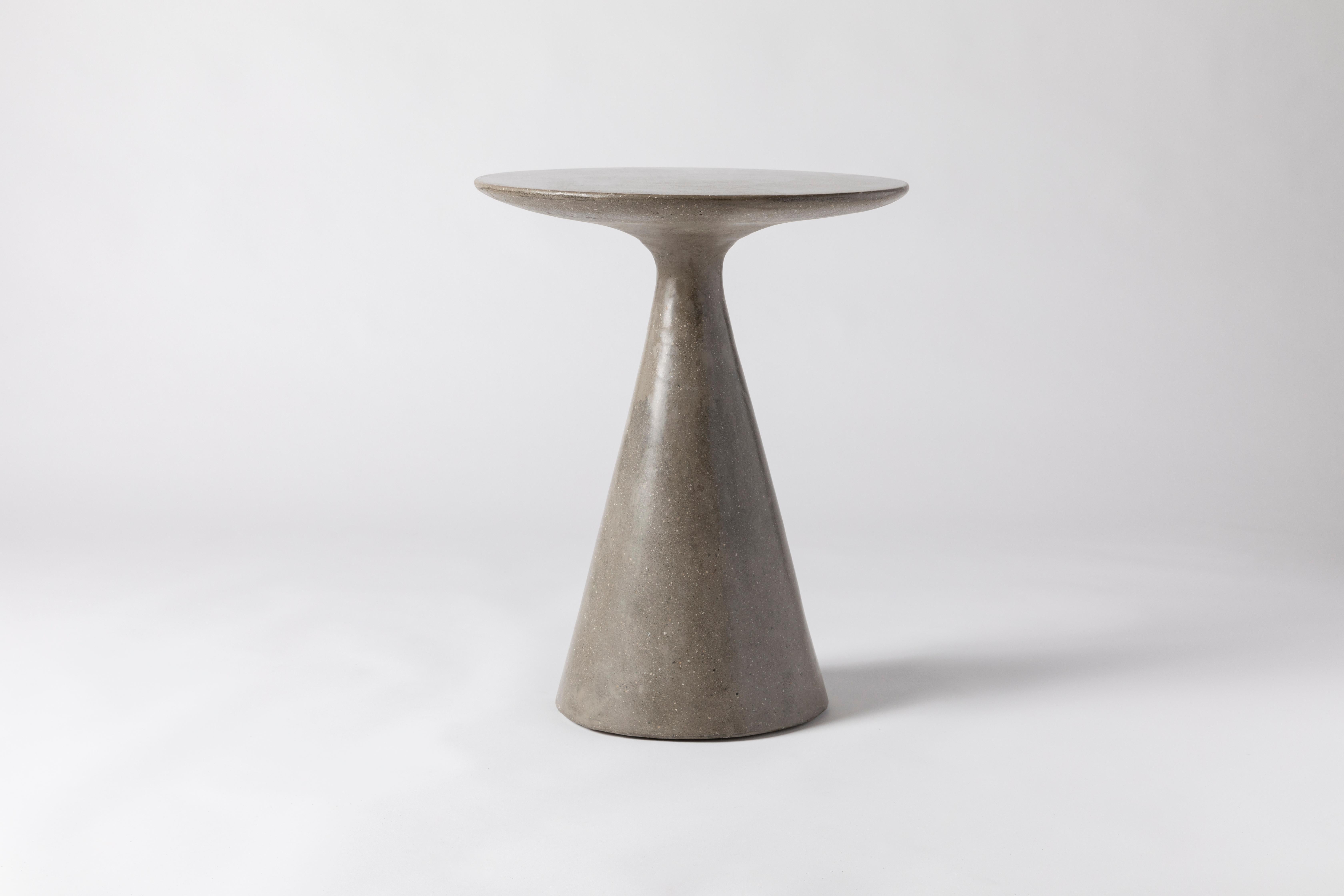 This simple, elegant side table is constructed of one solid piece of concrete. Its low center of gravity offers grounding and stability. This table lends a high level of sophistication to any setting.

Available in color options: Light Grey,