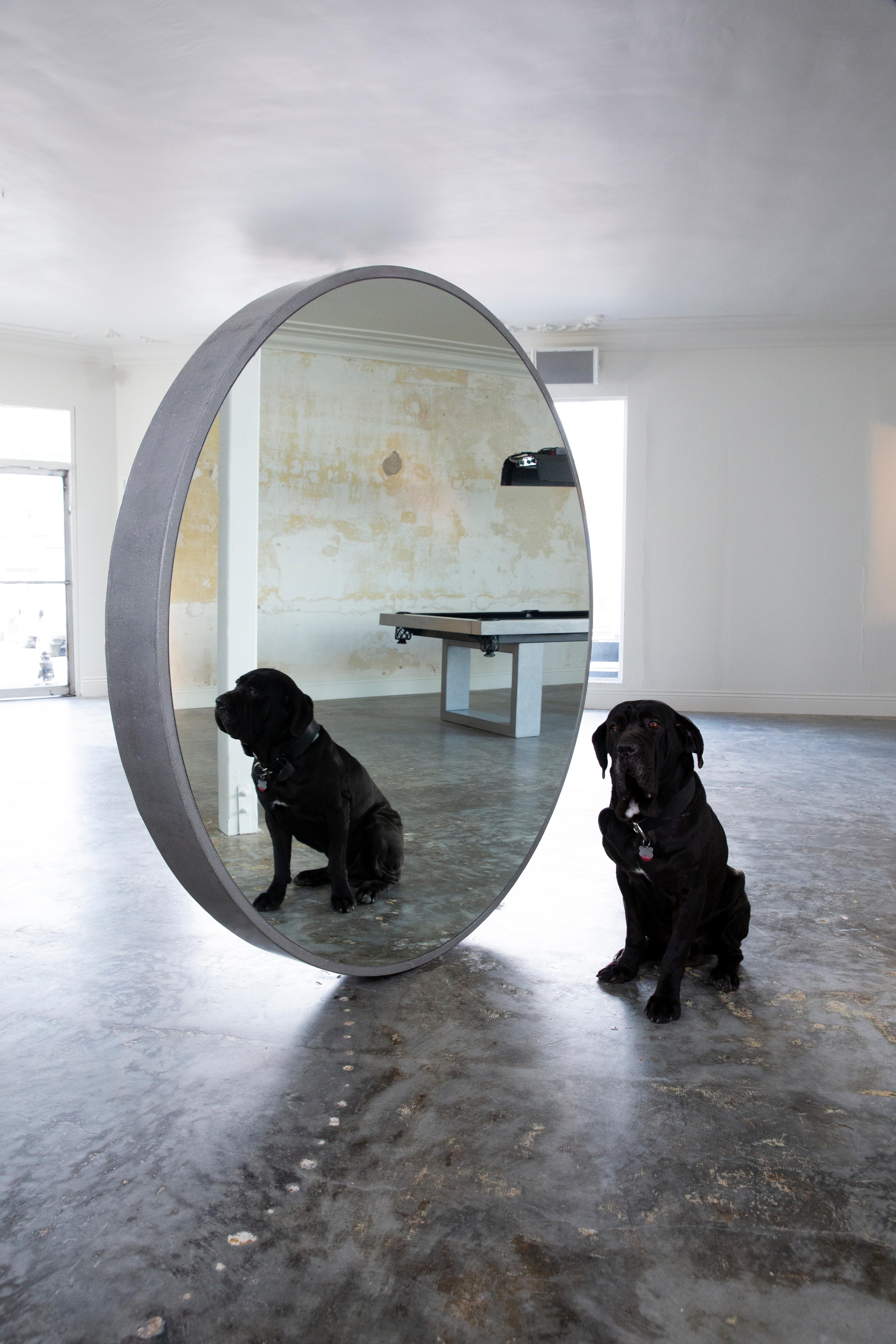 The James de Wulf Concrete Round Standing Mirror is a sight to behold. Decorative and functional, the mirror enhances the beauty of a room by creating an illusion of scale. Fits in a large space to create the appearance of a larger space. Perfect