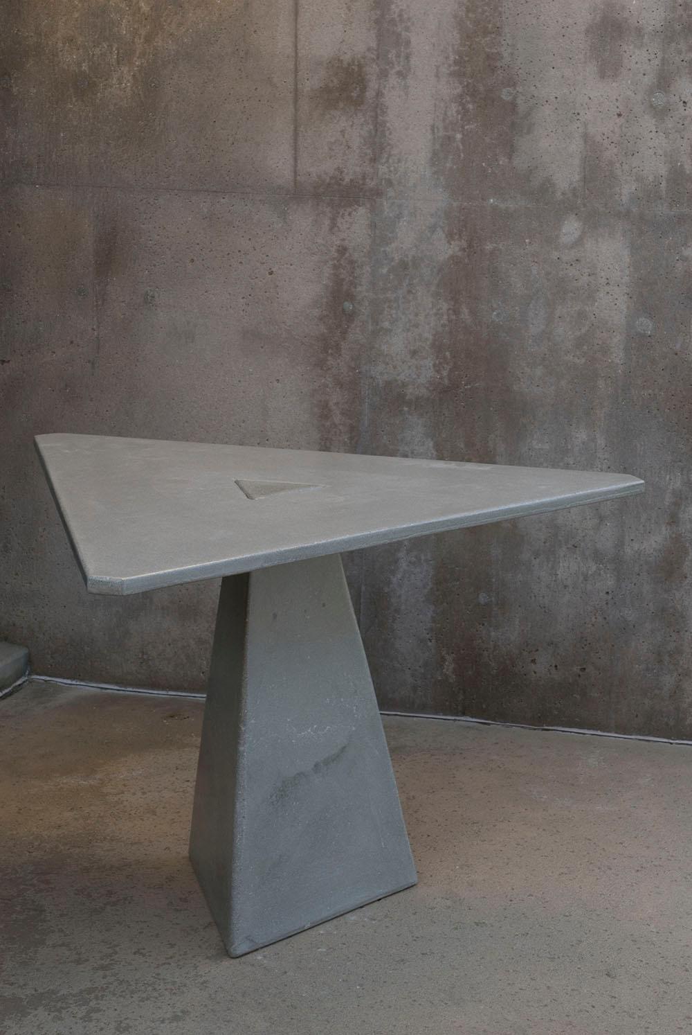 This is where we gather for tea. The triangular locking table features two pieces of concrete: triangular tabletop and base, which lock together by gravity alone. Equal in art and utility, the table serves as a collector's piece and as a functional