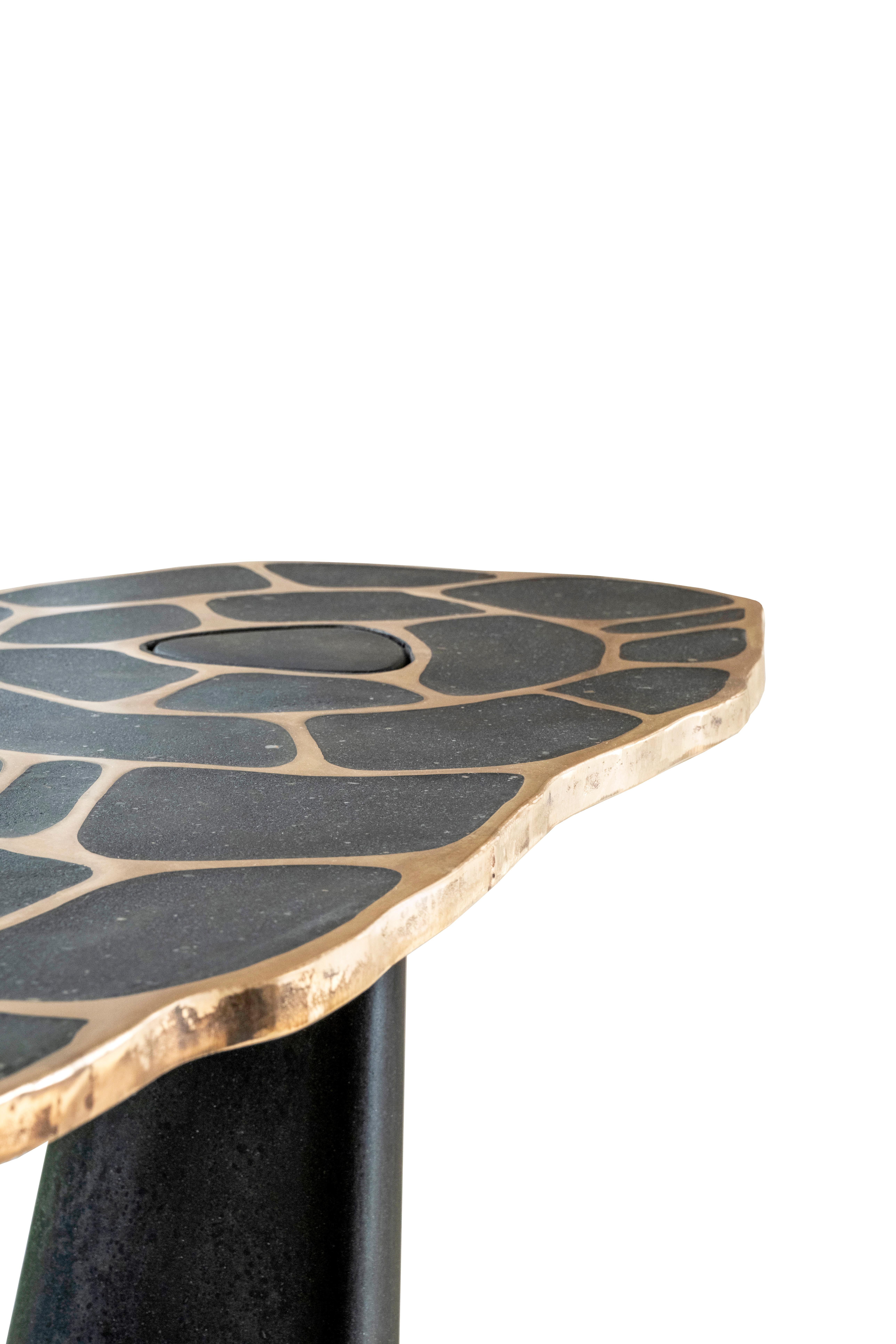 The Leaning Lotus Exo Console was designed to accompany the original Lotus Exo Dining that started the series back in 2021.
The base of the table leans strikingly while supporting the bronze adorned concrete top. The Lotus patterned top is fixed by