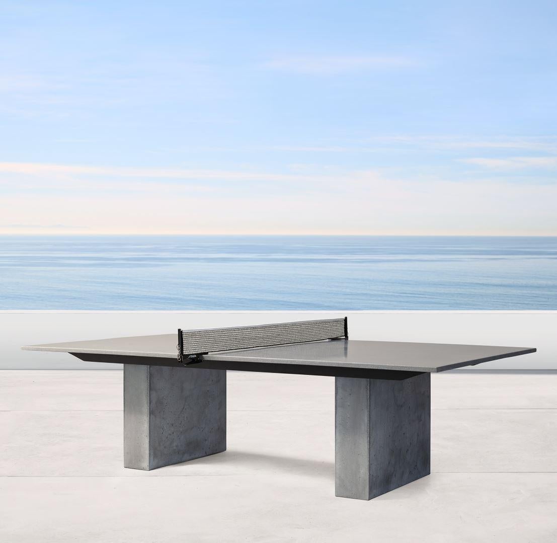 Eine spezielle Neuauflage des klassischen James de Wulf Ping Pong Tisches mit einem Paar massiver Betonbeine und einem rohen Kanten-Detail. Vorschriftsmäßige Größe mit einer säurebefleckten Mittellinie. Die verstärkte Tischplatte aus Gussbeton hat
