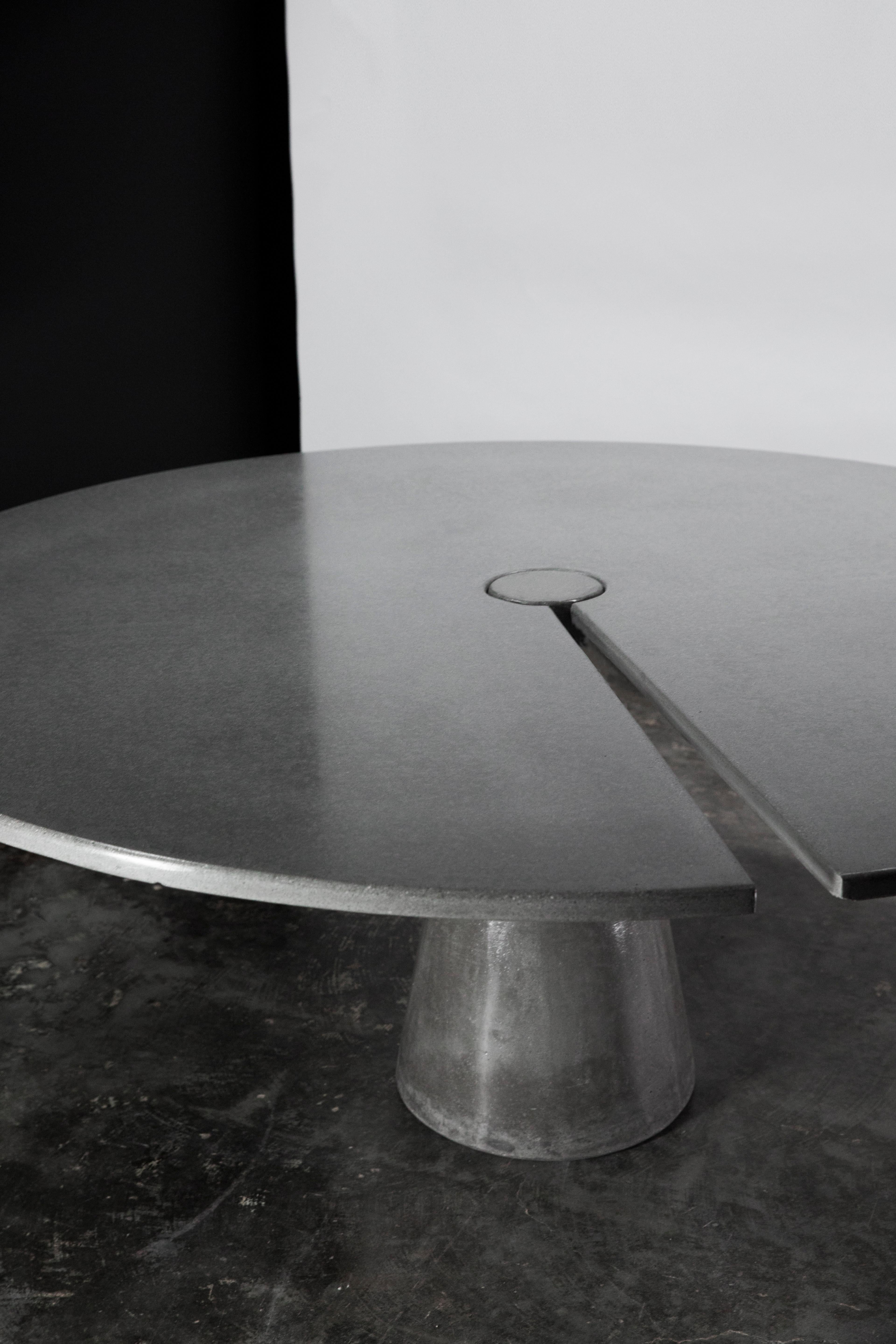 The James de Wulf classic Split Locking Dining Table features a split radius in the tabletop. The table consists of two pieces: table top and base, which are locked together by gravity alone. Equal in art and utility, as a collector's piece and as a