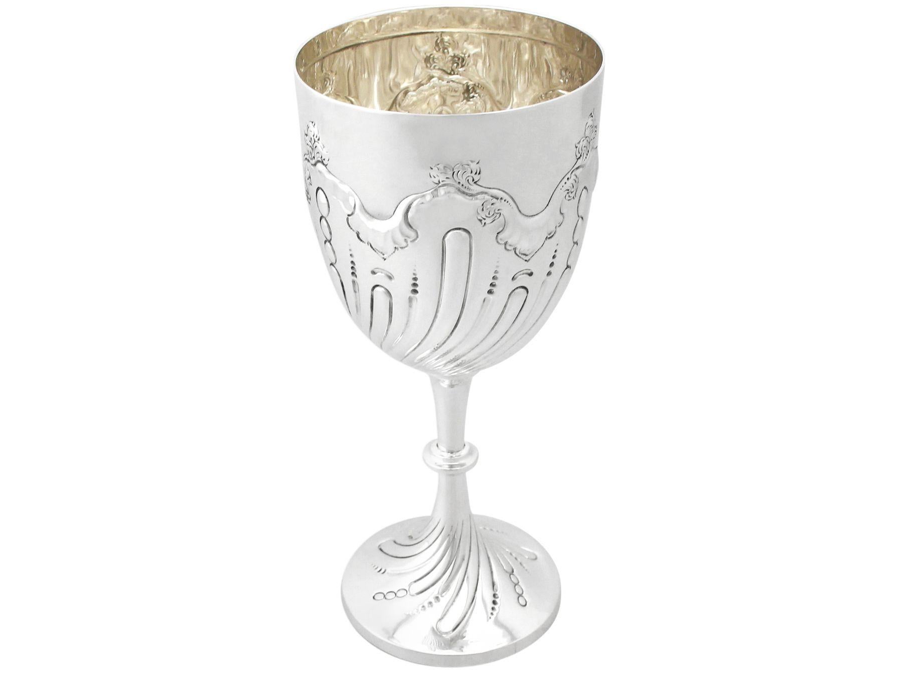 An exceptional, fine and impressive antique Victorian English sterling silver presentation cup; an addition to our presentation silverware collection.

This exceptional antique Victorian sterling silver presentation cup has a plain circular bell