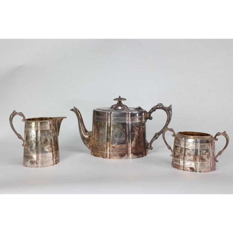 James Dixon and Sons. An Aesthetic Movement Electroplated Brittania metal tea set consisting of a teapot, milk jug, and sugar bowl. Teapot 16x17x17.  Milk Jug 13x13x7. sugar bowl 9x15x7cms.

