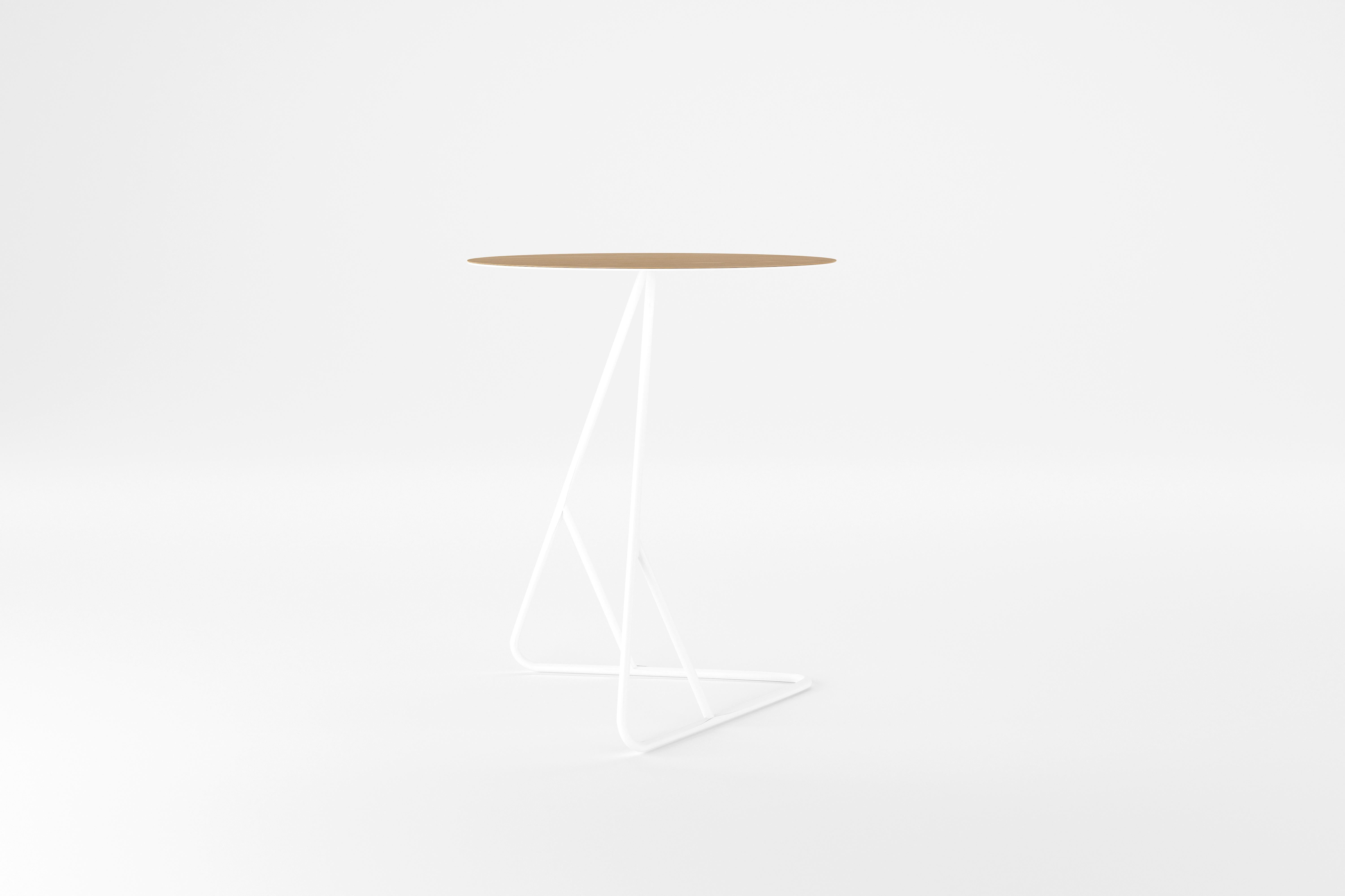 Seemingly defying the laws of nature, this Danish-inspired design is composed of a razor thin metal top covered with oak veneer, atop an elegant wire base. The warmth of the wood grain adds a level of complexity balancing the minimalist base for a