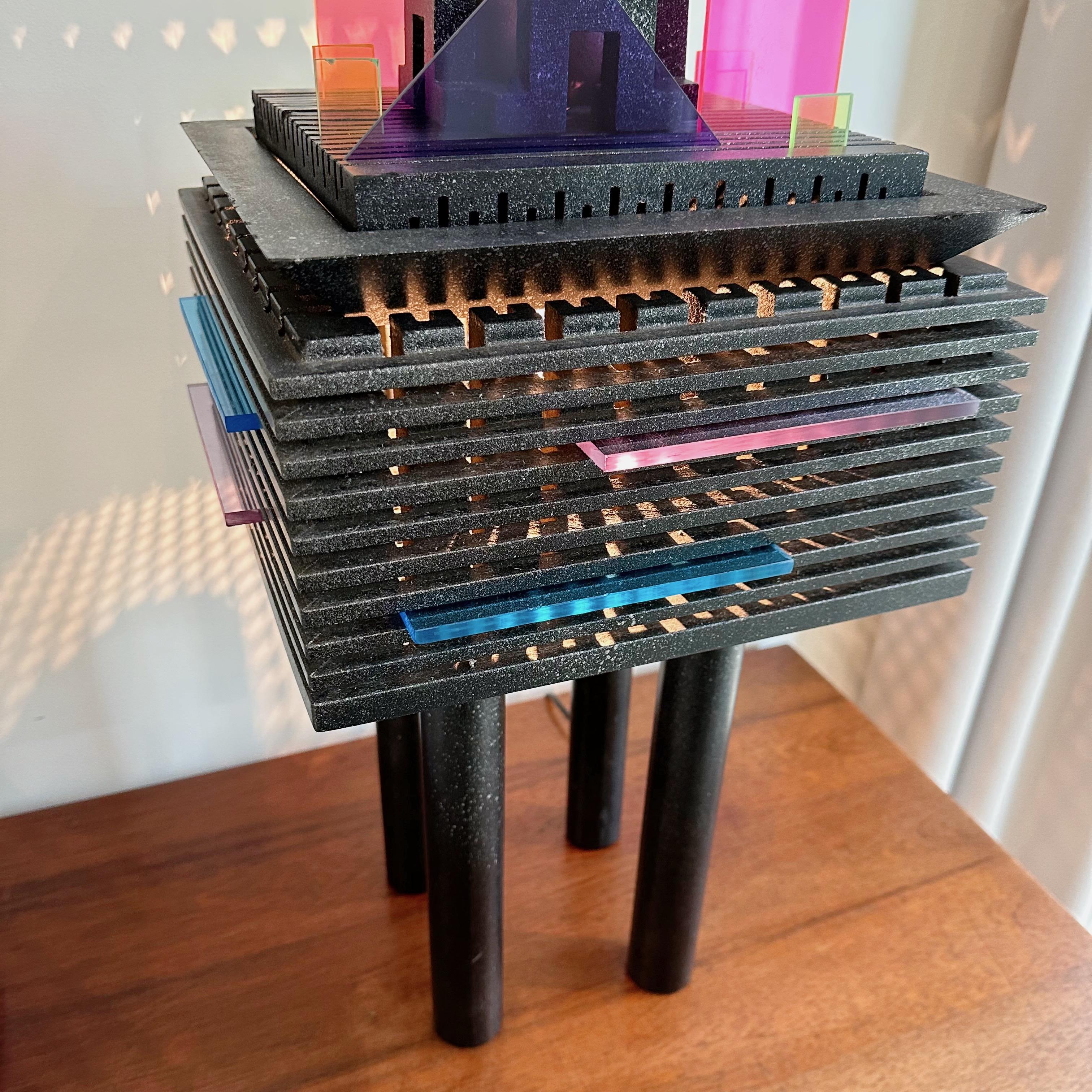 This “Lighthouse” table lamp by James Evanson from the 1984 is wired for US outlets and has been repaired / restored by the Selby House. Inspired by both modern architecture and design principles of the Memphis Group, these lamps received world-wide