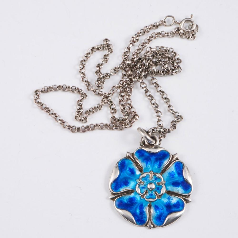 Maker: James Fenton

Description: Tudor Rose pendant in blue enamel

Year: 1918

Origin: Hallmarked in Birmingham 1918

Size : The pendant 3.1cm, with chain 25cm

Weight : 12 grams, 38 grams boxed

Condition: Excellent, no enamel loss and chain in