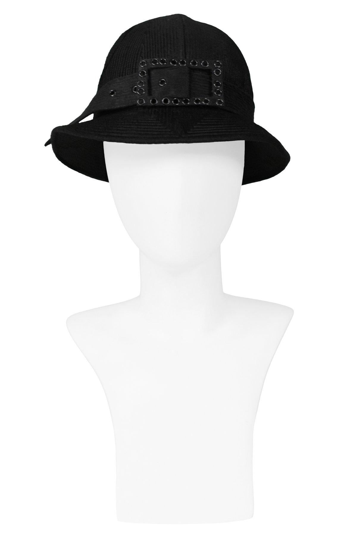 Resurrection is pleased to offer a vintage Galanos black wool fancy hat with detailed stitching and a large buckle at the front. 

Galanos
James Galanos
One Size
Wool
Excellent Vintage Condition 
Authenticity Guarantee