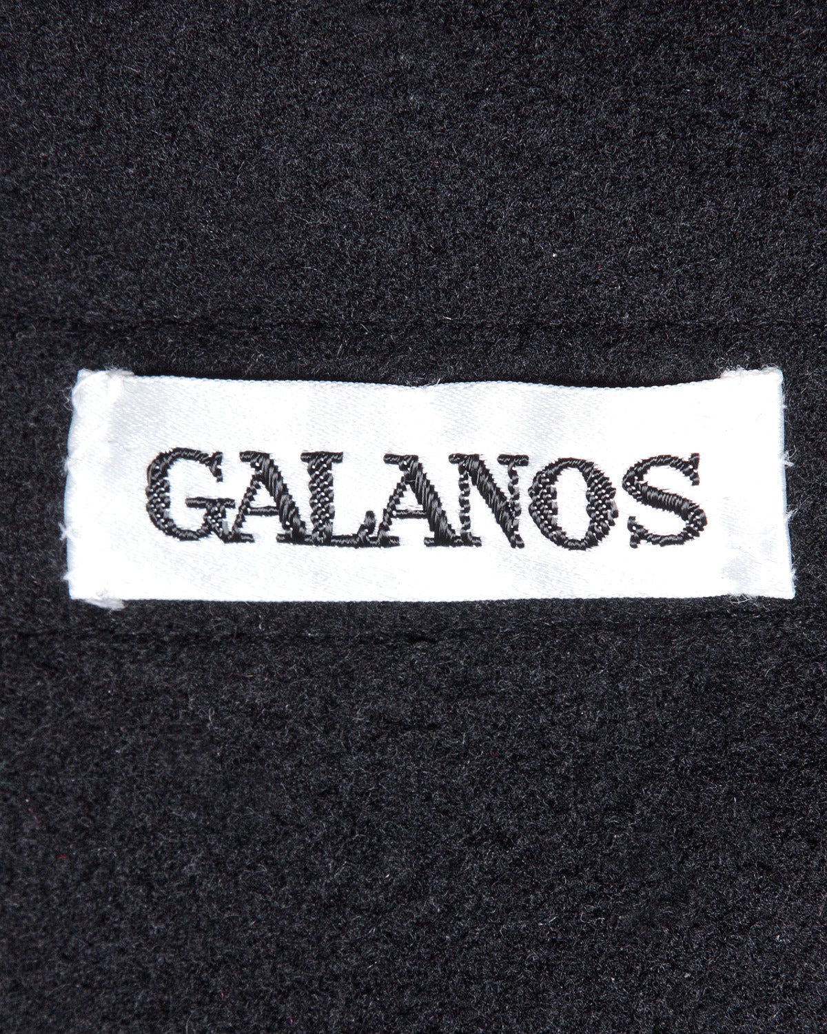 Beautiful heavy wool (It feels like there might be cashmere mixed in. The fabric is extremely soft.) coat by James Galanos for Neiman Marcus. Long sleeves and belt that buttons on and off. Rounded hem with side slits and cape-like cut. Sleeves can