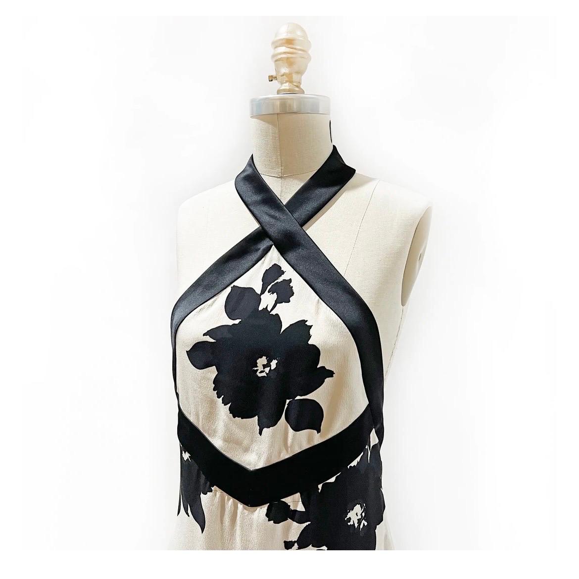 James Galanos Halterneck Gown
Vintage 
Circa late 1980's or early 1990's 
Made in the United States 
Black and White 
Floral print 
Silk 
Black satin halter neckline 
Empire waist 
Column style gown 
Open back hits mid-back
Invisible zipper down