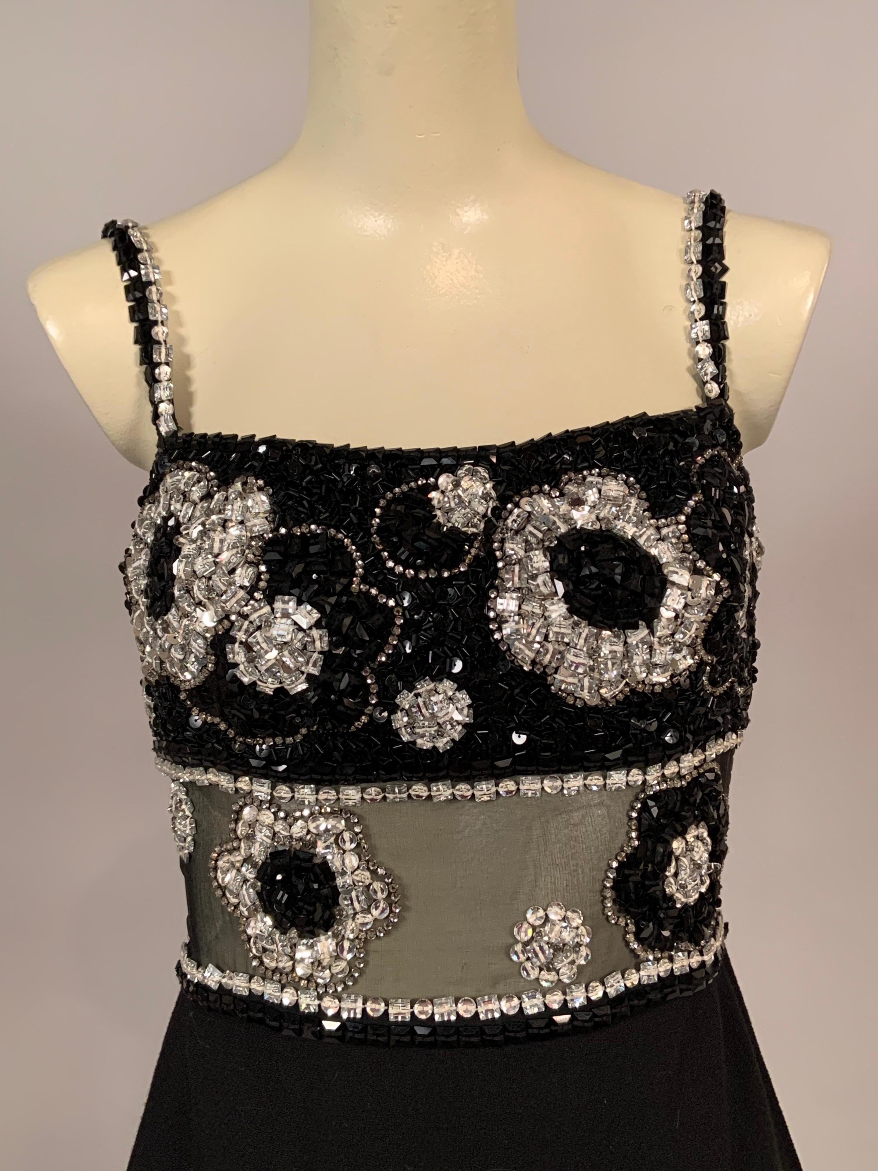 This dress is a stunning example of thr couture level workmanship and design that James Galanos was famous for producing. The dress bodice is encrusted with jewels, clear emerald cut rhinestones, prong set rhinestones, silver sequins, bugle beads,