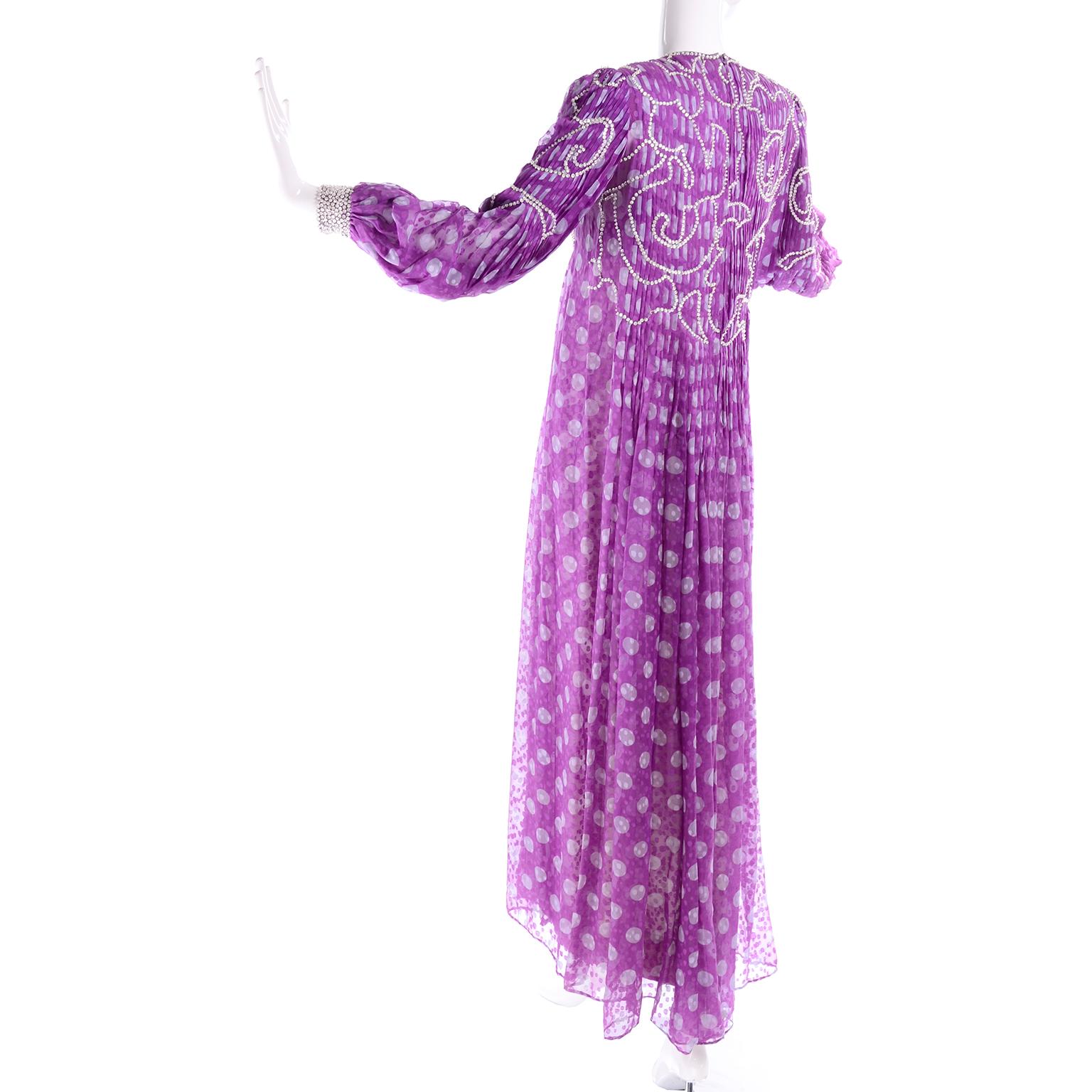 This is a sensational rare vintage James Galanos purple polka dot silk chiffon dress with silver beaded sequins and heavy pleats. The long sleeve semi sheer over dress has knife pleating held in place by swirling lines of sewn-in beads through