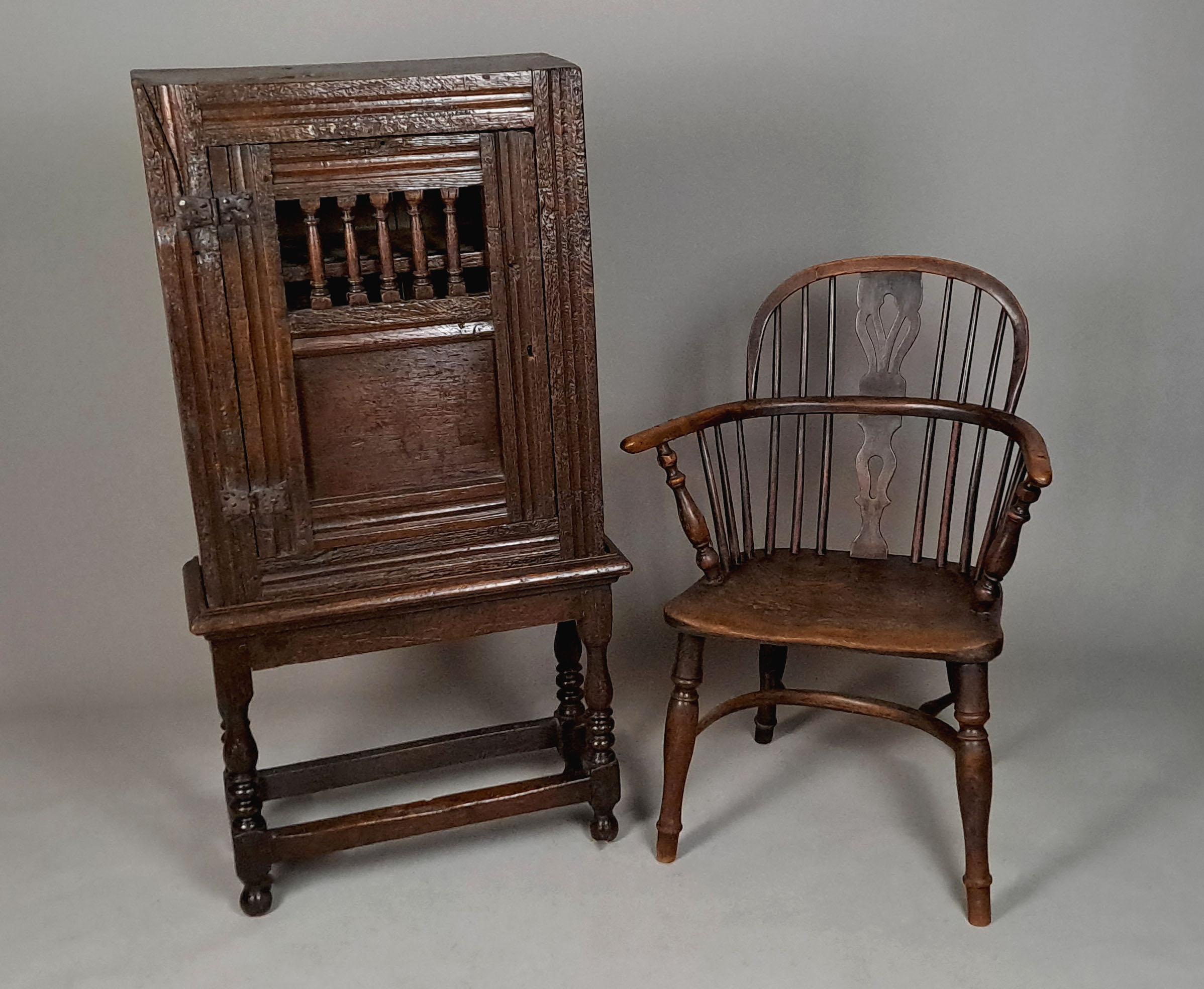 A good early 17th Century English oak mural livery cupboard used for storing rations of food, candles and beer.

These ventilated small mural livery cupboards were sometimes built into walls or wall hung or, as here, placed on a stand.  The