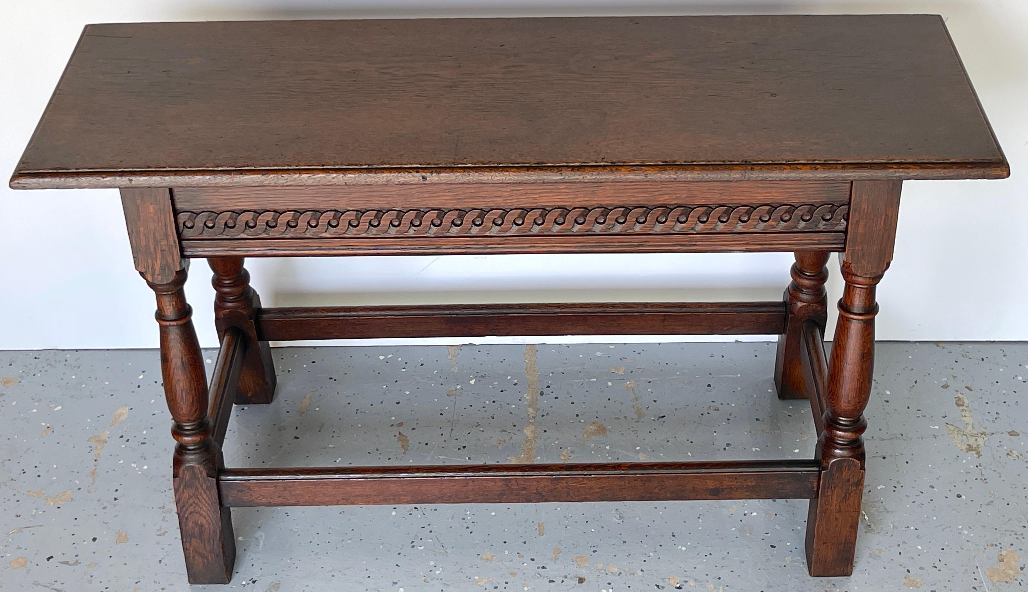 James II Style Carved Oak Bench/ Side Table, England, 1920s 
This versatile piece exemplifies the refined and understated elegance of the James II style, known for its classical influences and fine craftsmanship.

The bench/side table features a