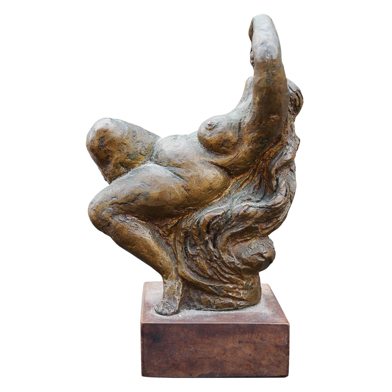Modern abstract figurative sculpture of a nude woman by the artist James Kearns. The work features a reclining female figure with long flowing hair relaxing and eating grapes. Signed by the artist in the cast on the back of the pillow the woman is
