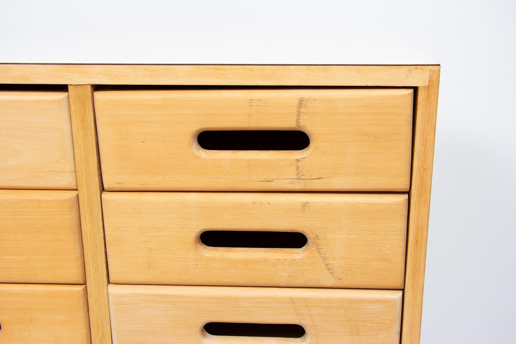 A midcentury chest of school drawers designed by James Leonard in the early 1950s for Esavian (ESA) The Educational Supply Association.