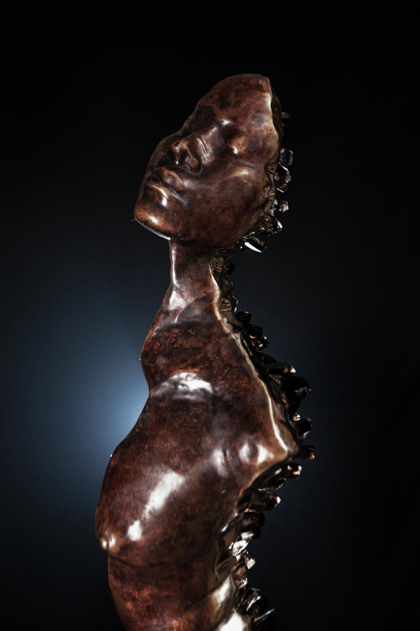The sculpture is patinated bronze with naturally occurring smokey quartz crystals. 

Unique edition.
Half torso.

The cementitious pedestal base is unique and hand-made in the artists' studio under the watchful eyes of the artist.

The artist is