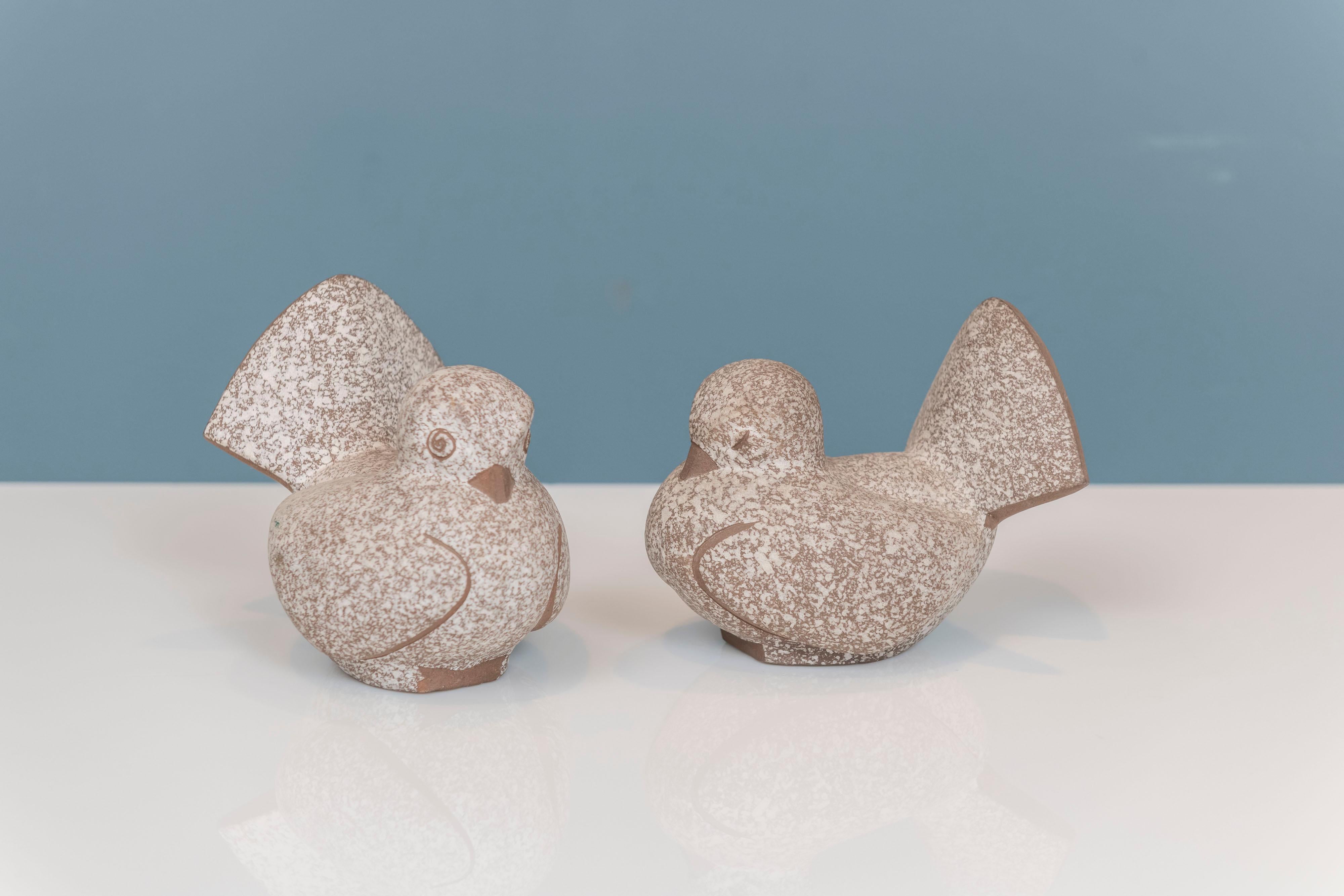 James Lovera designed love birds depicting two birds in courtship. Executed in ceramic with a speckled or frosted glaze, signed Lovera.