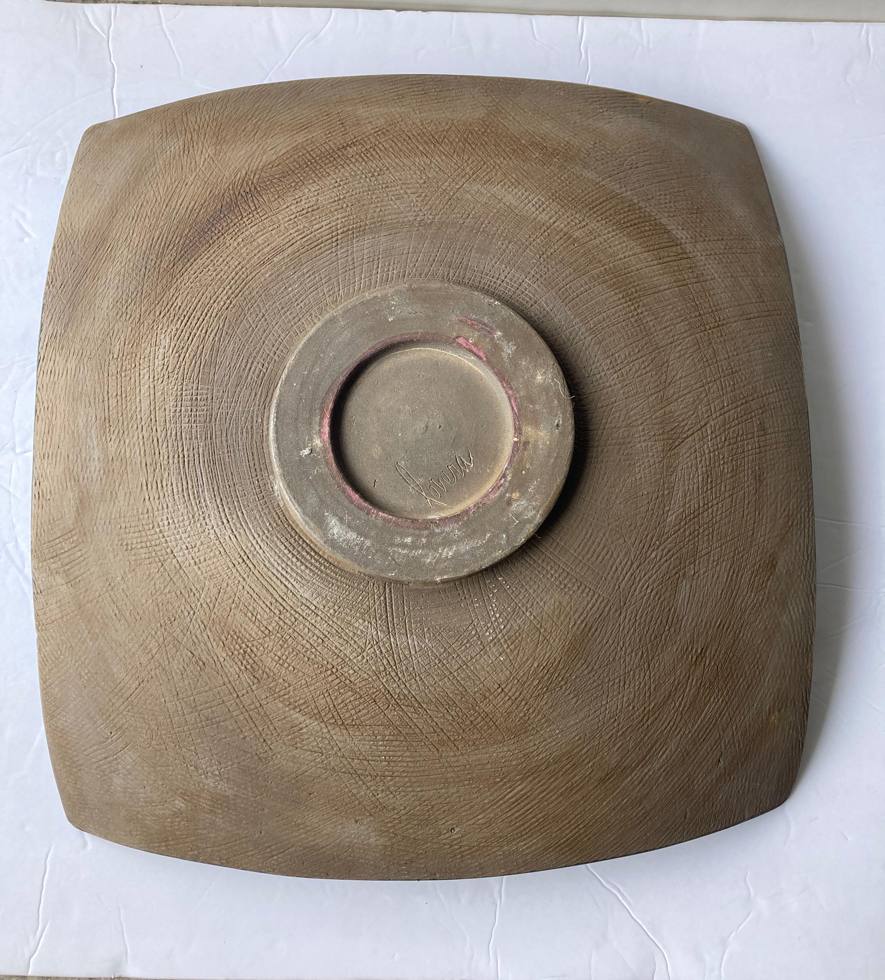 Very unusual square/round, shape centerpiece by the well known California potter. Has an olive green volcanic /lava glaze and brown under, signed Lovera. Note; one corner it goes as a hair 4 inches high.