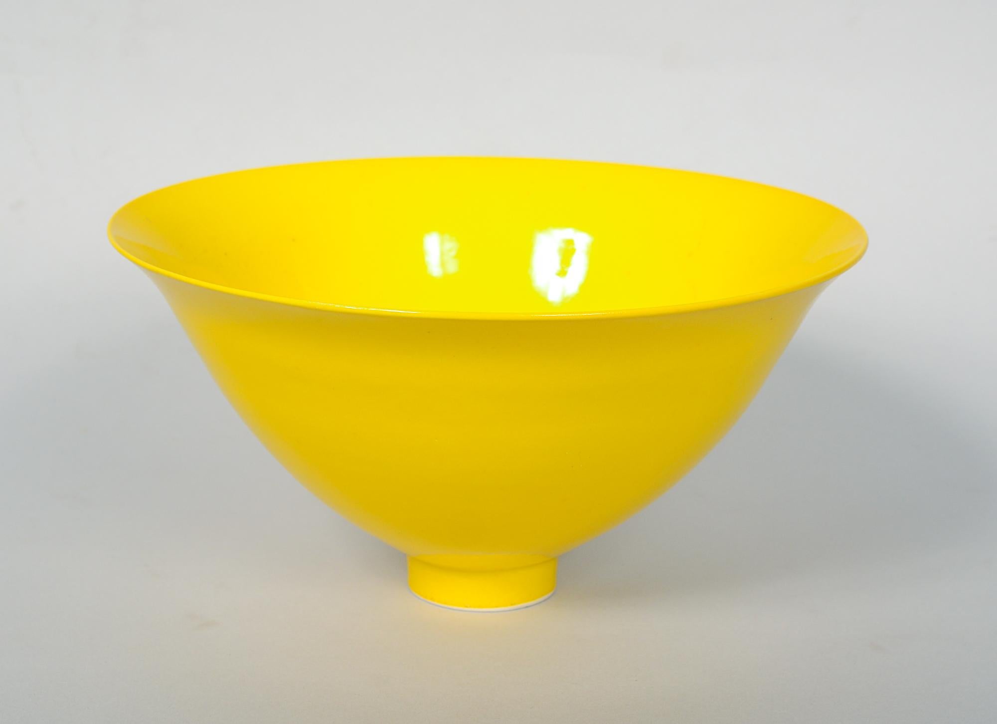 Porcelain bowl by James Lovera. This delicate thin walled bowl sits on a small foot and has a flaring rim. The bright yellow glaze suits the form perfectly. There is a glaze skip in the interior.

James Lovera (1920-2015) was born in Hayward,