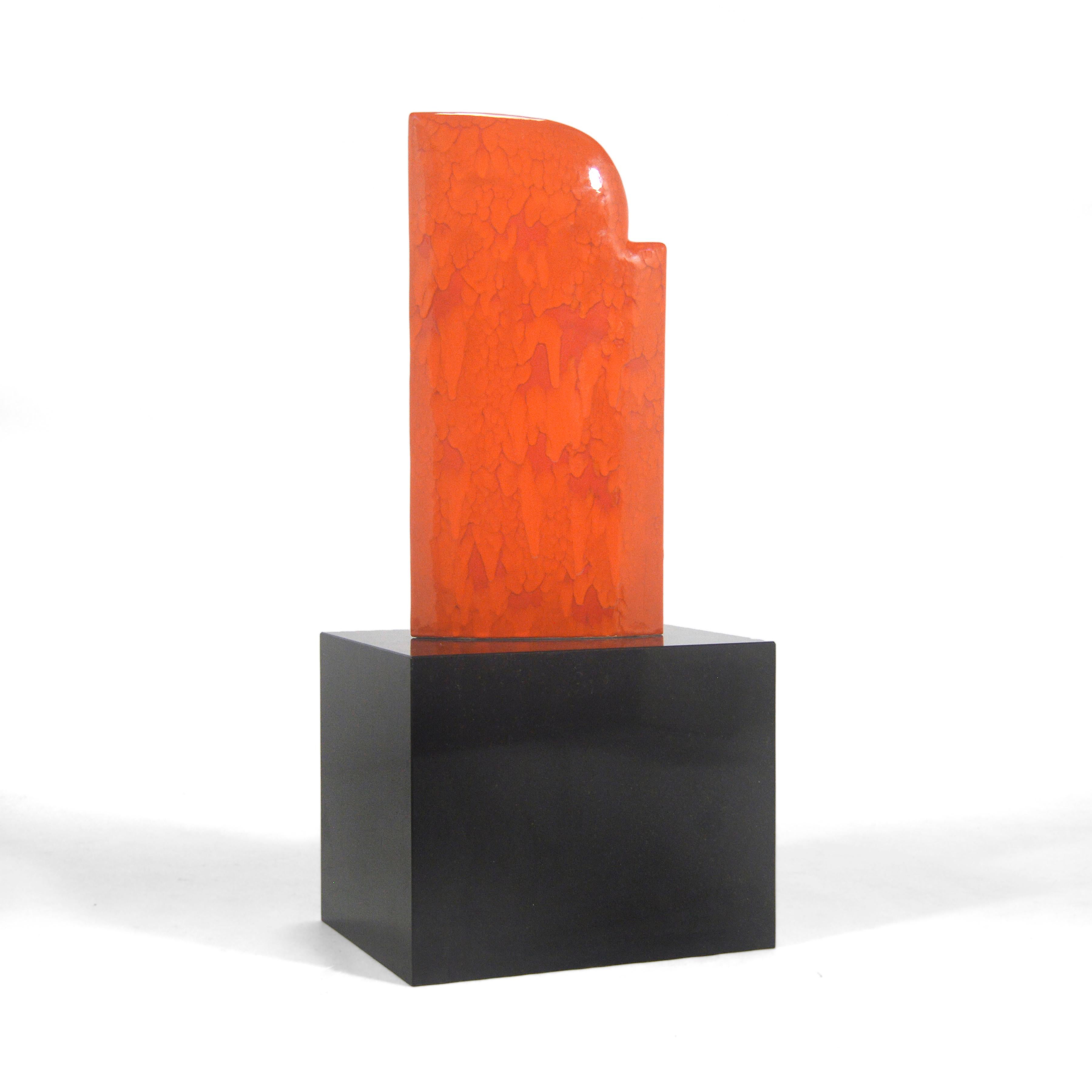 This stunning abstract ceramic sculpture by James Marshall features a minimalist form with a richly textured glaze in a vivid orange color. Executed in 2006, it is fixed to a black stone plinth.

James Marshall (b. 1949) has exhibited widely,