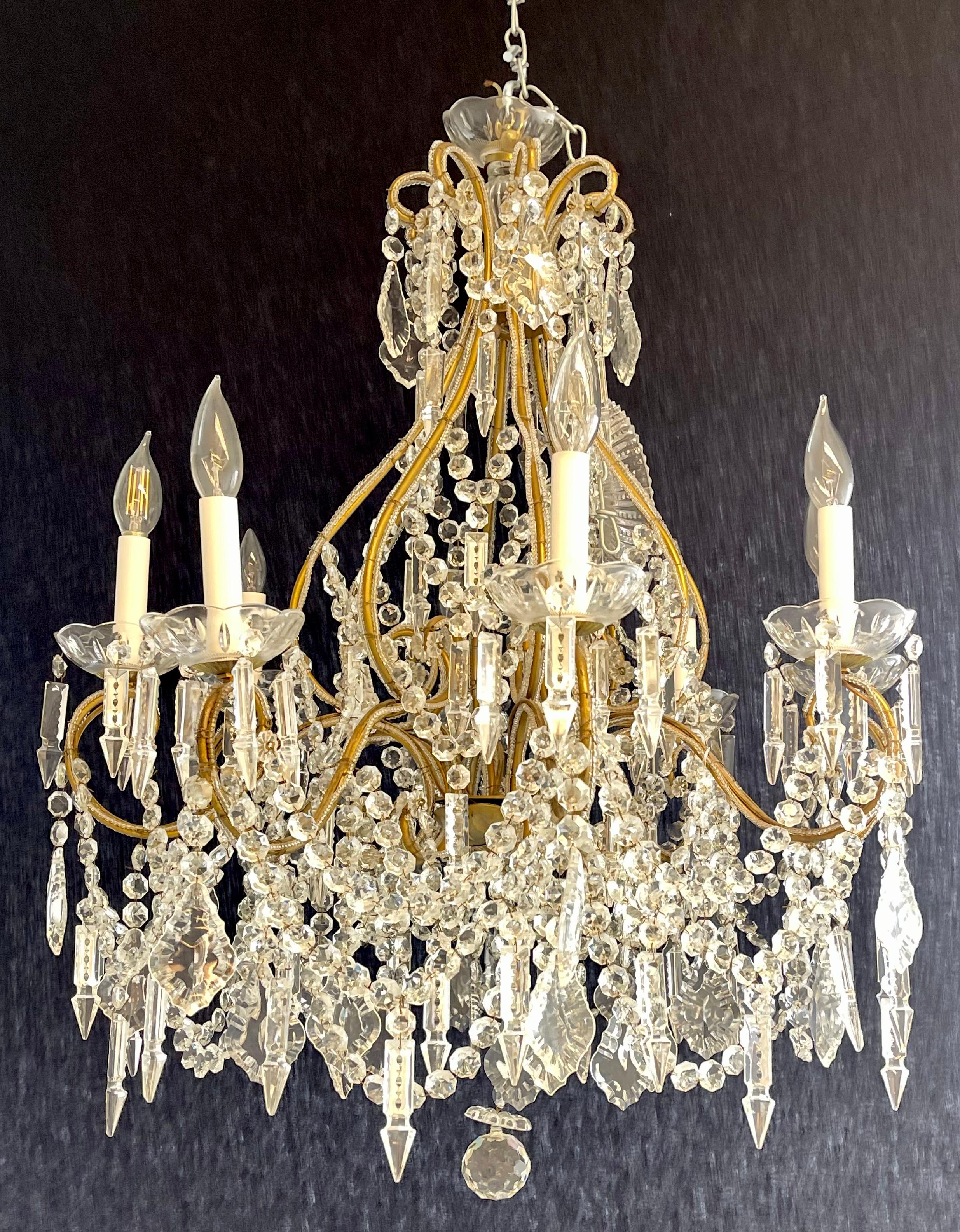 A fine James Moder Crystal Chandelier. Elegant look on this overstated chandelier which is large enough to fit into most settings. 