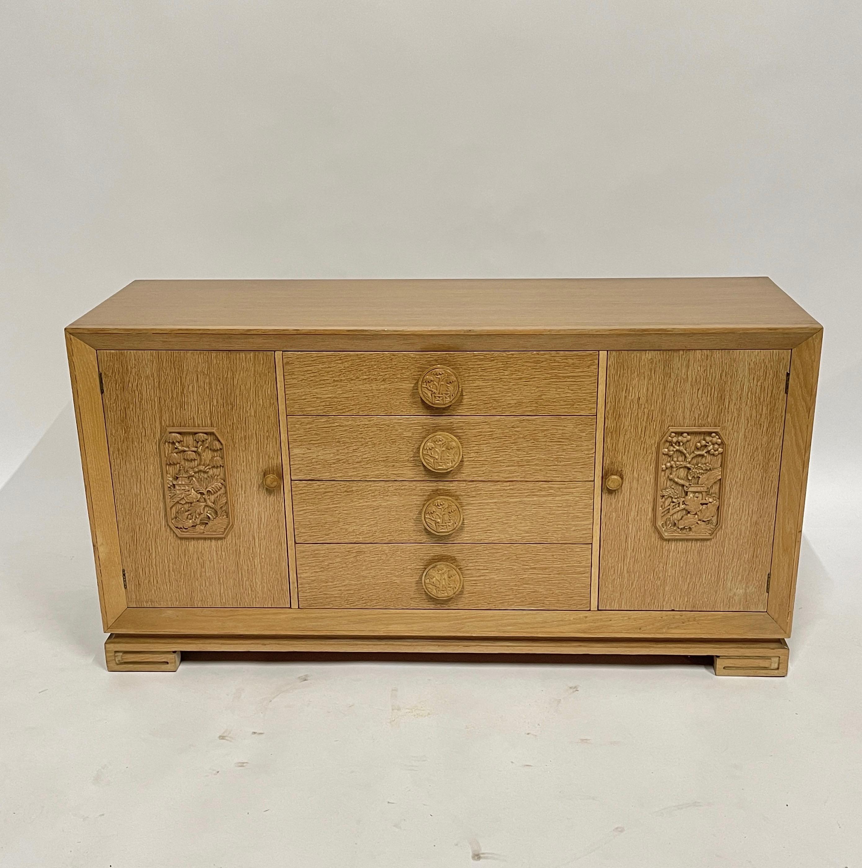 James Mont attributed coursed oak four drawer and two-door cabinet with shelves and interior drawers. Lovely carved doors and oversized drawer pulls. Asian inspired chinoiserie bureau from the 1940s in very nice original condition.