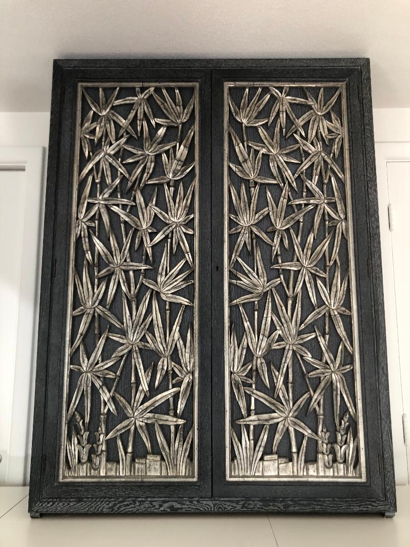 Superbe armoire murale en bambou sculpté des années 1950 par James Mont en excellent état d'origine.
Le meuble en chêne cérusé à grain ouvert présente de magnifiques panneaux en bambou sculpté à la feuille d'argent qui s'ouvrent sur trois étagères