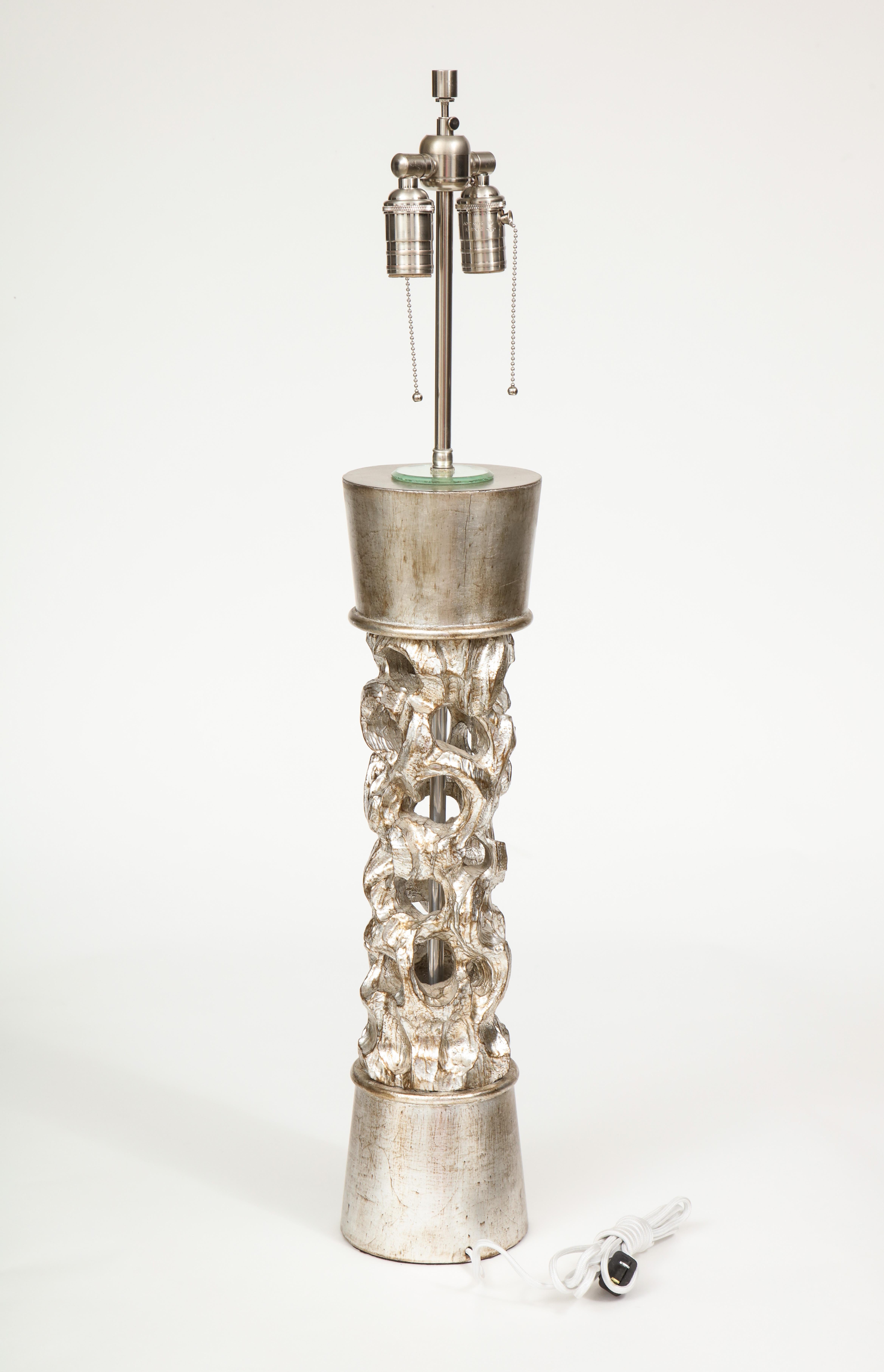 Exquisite carved wood column lamp with a silver leaf finish by James Mont. Rewired for use in the USA. 60W max each socket.
