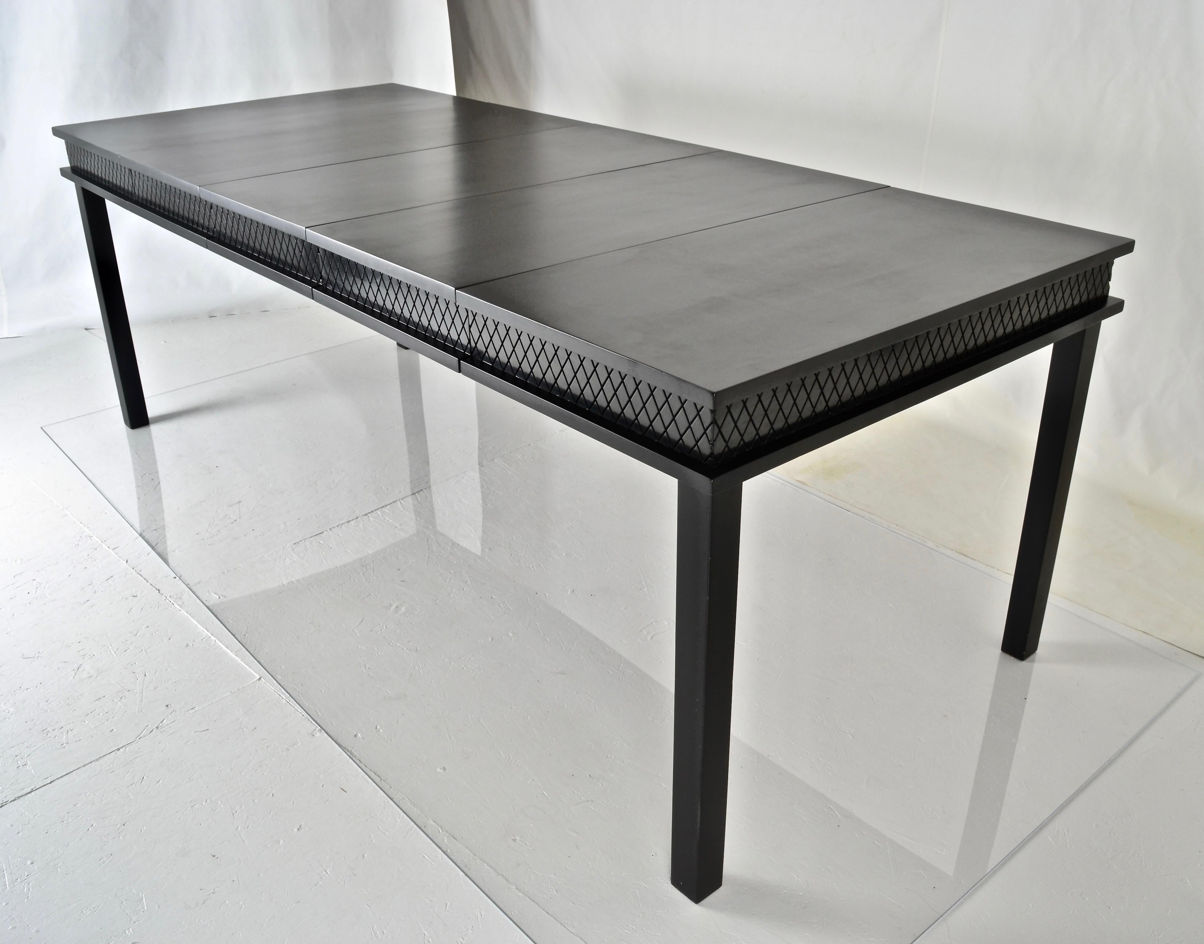 This James Mont dining table with four accompanying chairs has been newly lacquered in satin black with the table apron in gloss black. The table expands from a 36