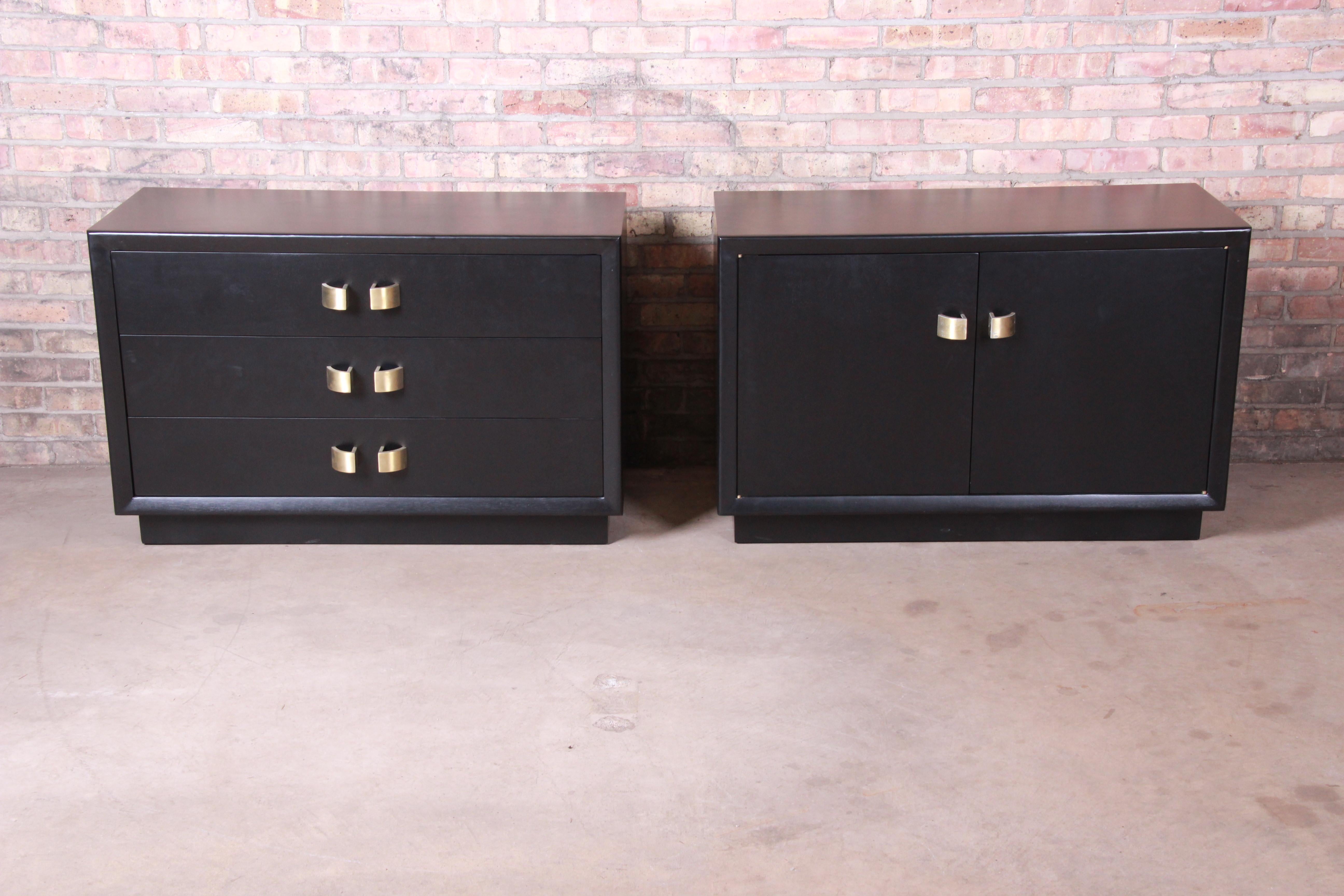 A gorgeous pair of Mid-Century Modern Hollywood Regency ebonized chests or large nightstands. One featuring three drawers; the other with a single shelf behind two cabinet doors.

Attributed to James Mont

USA, circa 1950s

Measures: 41.75