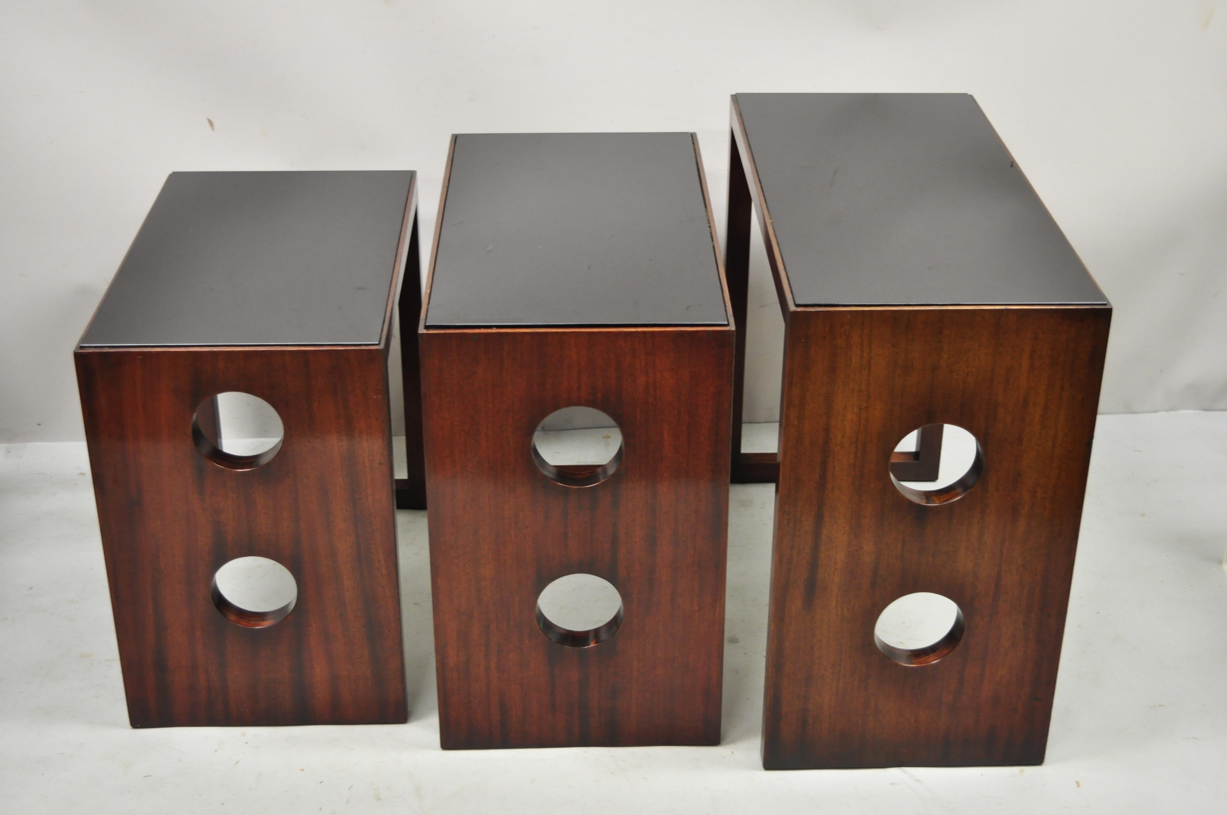 James Mont Mid-Century Modern mahogany & glass Top Art Deco nesting side tables. Set includes black glass tops, graduating size, very rare vintage set, clean modernist lines, quality American craftsmanship. Unmarked but attributed to James Mont.