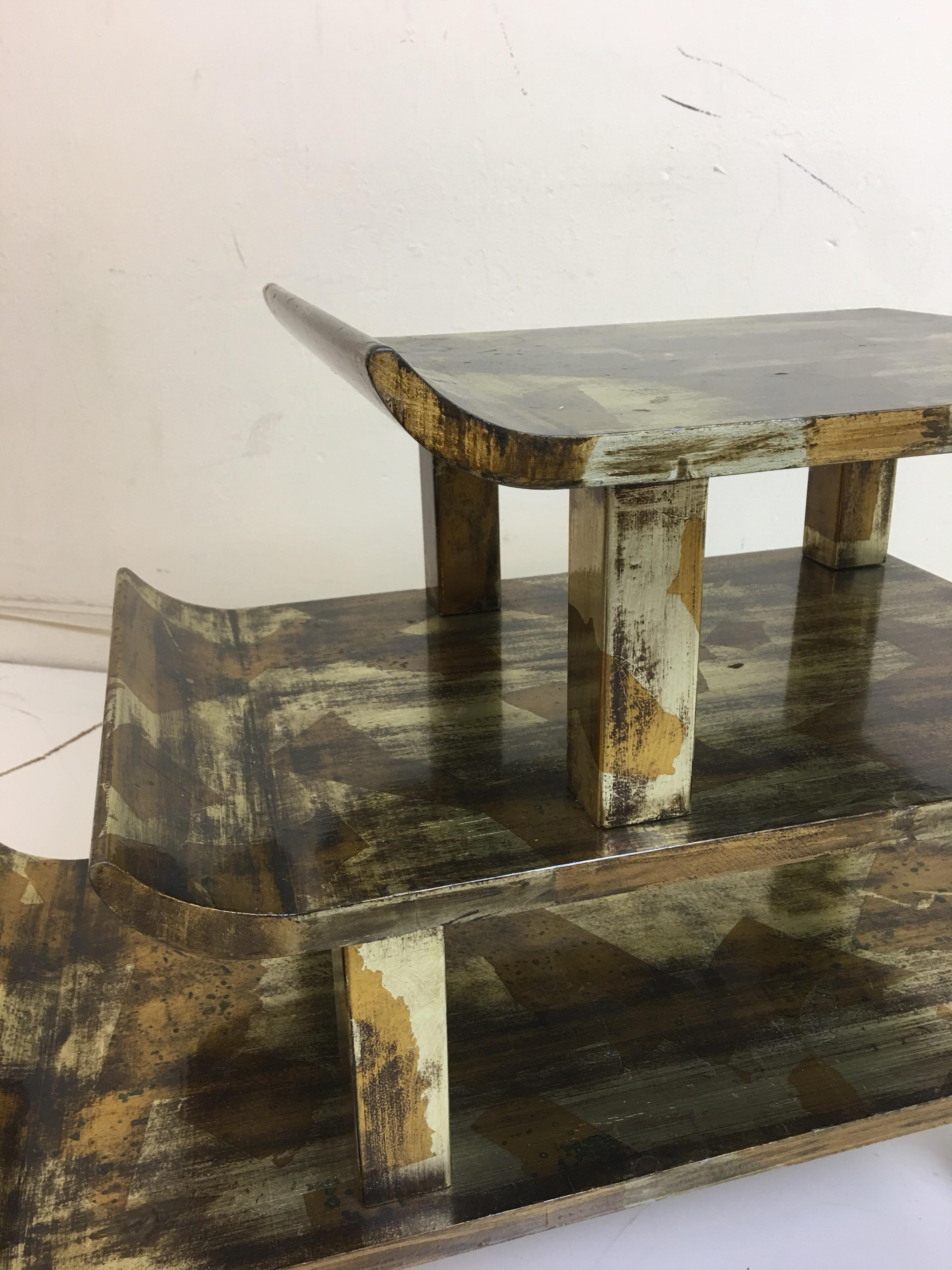 James Mont Pagoda step table in distressed gold and silver leaf finish.