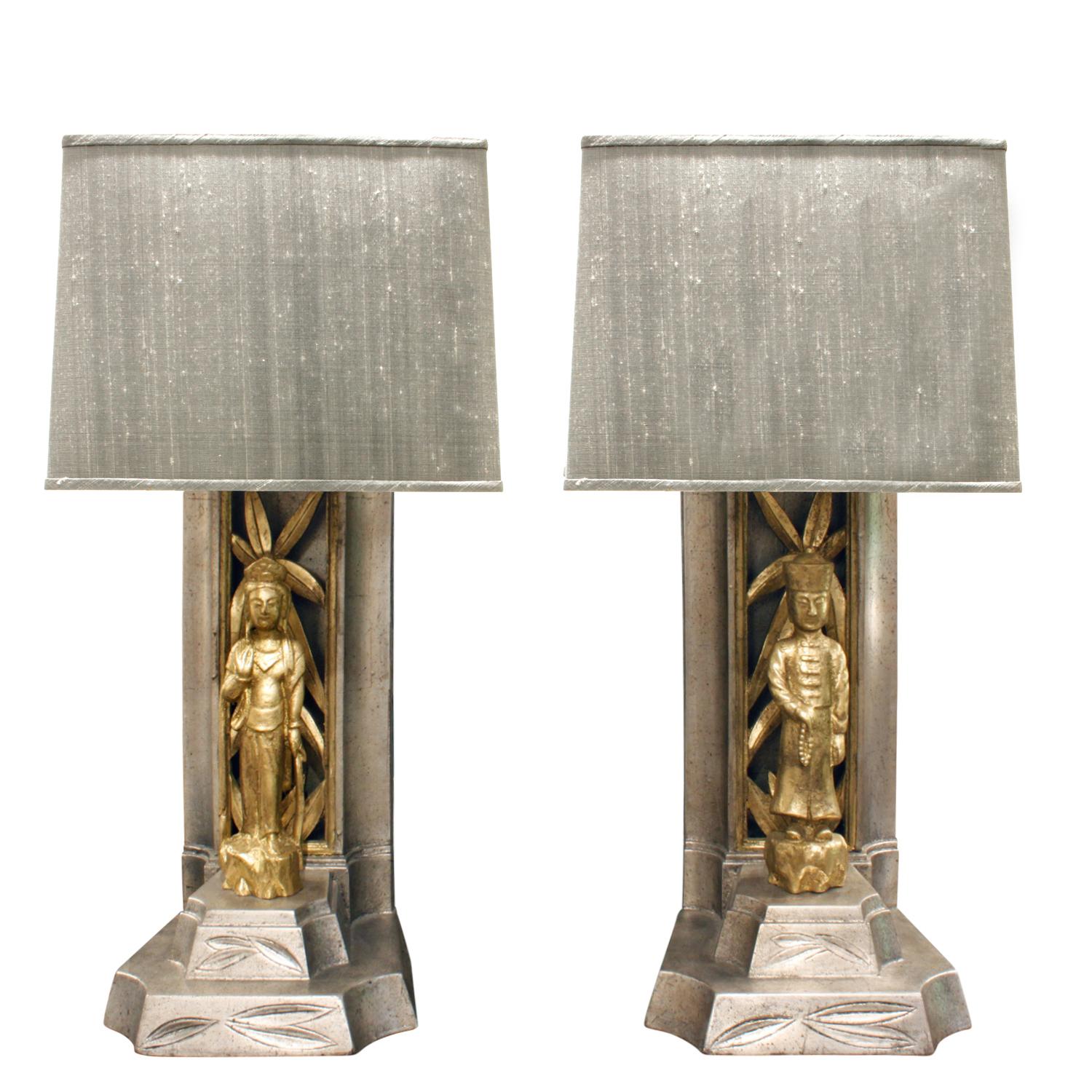 Pair of hand carved table lamps with Chinese figures decorated in gold leaf and white gold leaf by James Mont, American 1950's. New custom silk shades by Lobel Modern.  These iconic Mont lamps are very chic.