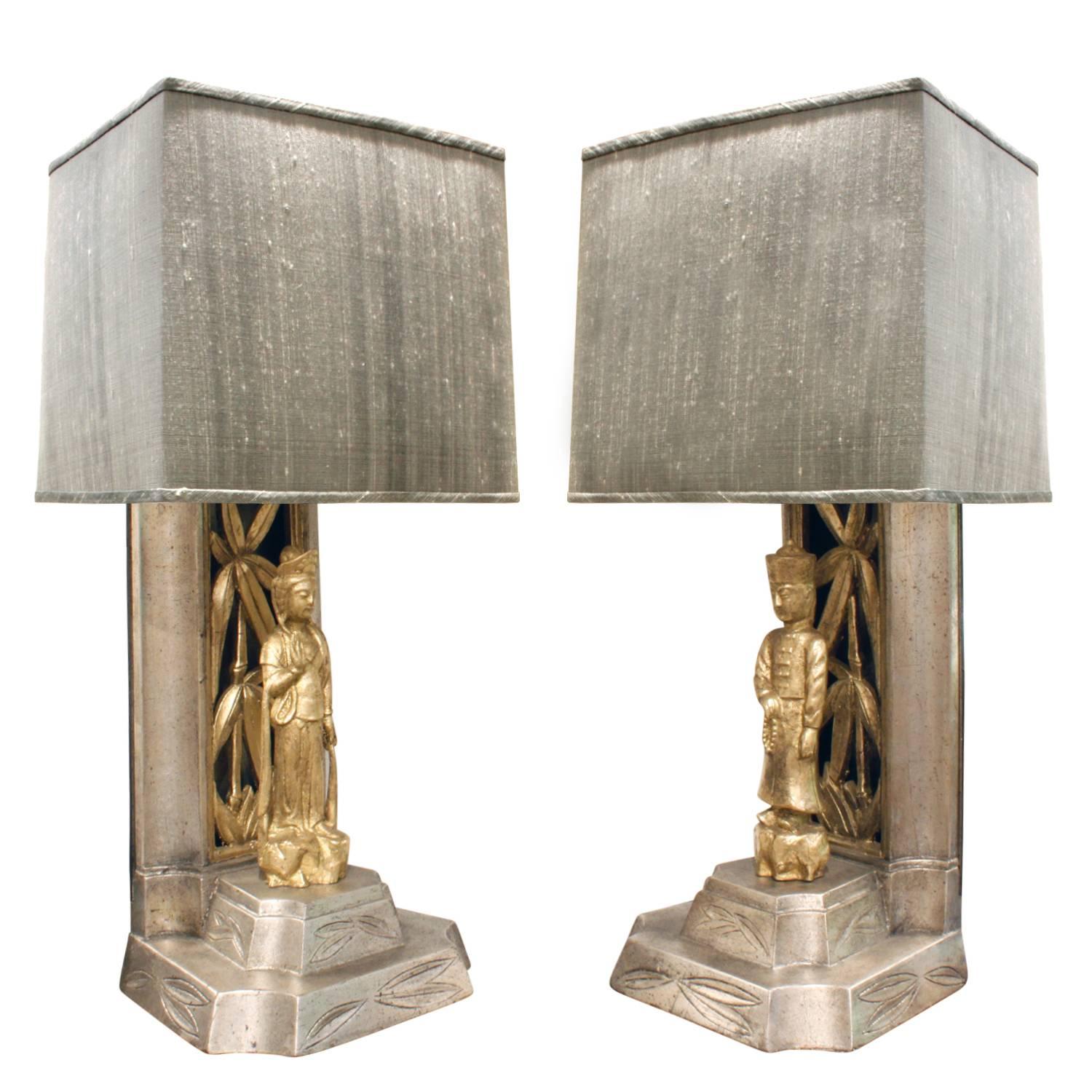 Pair of hand-carved table lamps with Chinese figures decorated in gold leaf and white gold leaf by James Mont, American, 1950s. New custom silk shades by Lobel Modern.  These iconic Mont lamps would make a beautiful addition to any room.