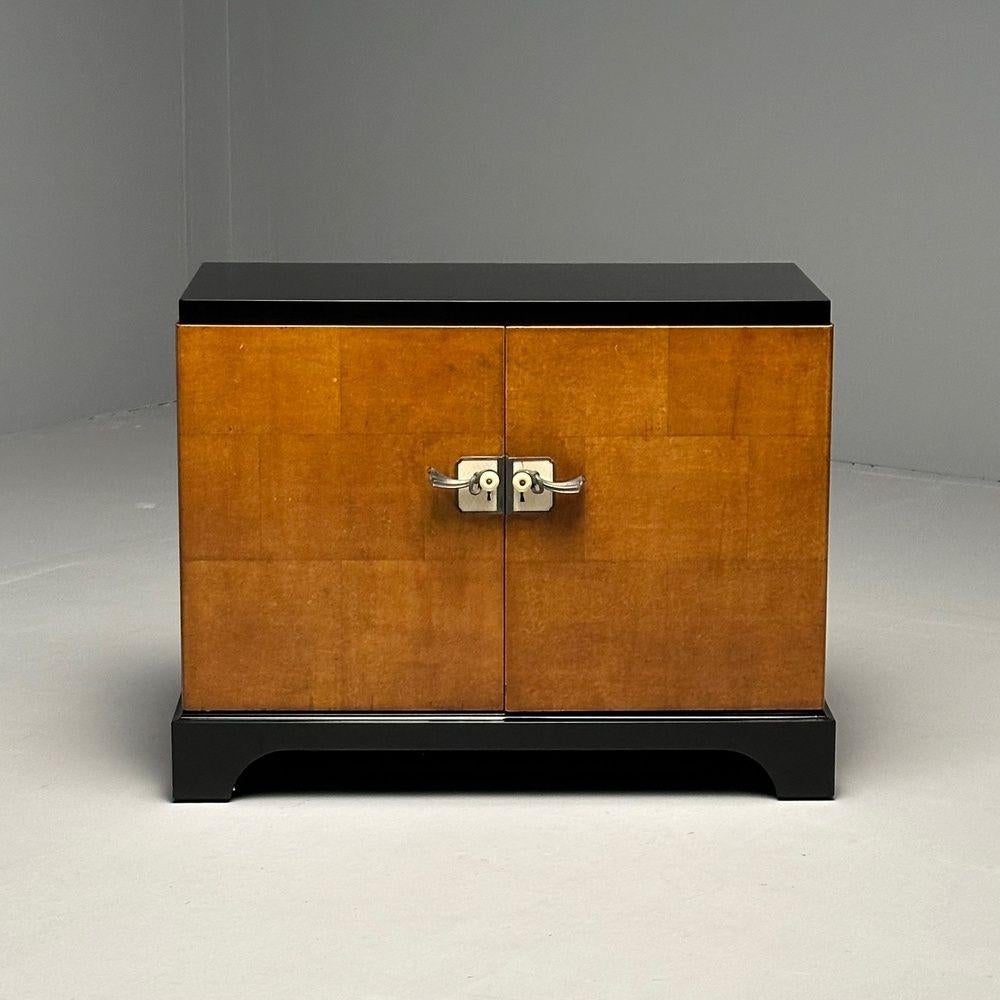 James Mont Style, Art Deco, Single Cabinet, Black Lacquer, Parquetry, France, 1930s

A distinctive cabinet or nightstand on bracket style ebony bases supporting an open box case made of inlaid burlwood parquetry. Two swing-out doors are secured with