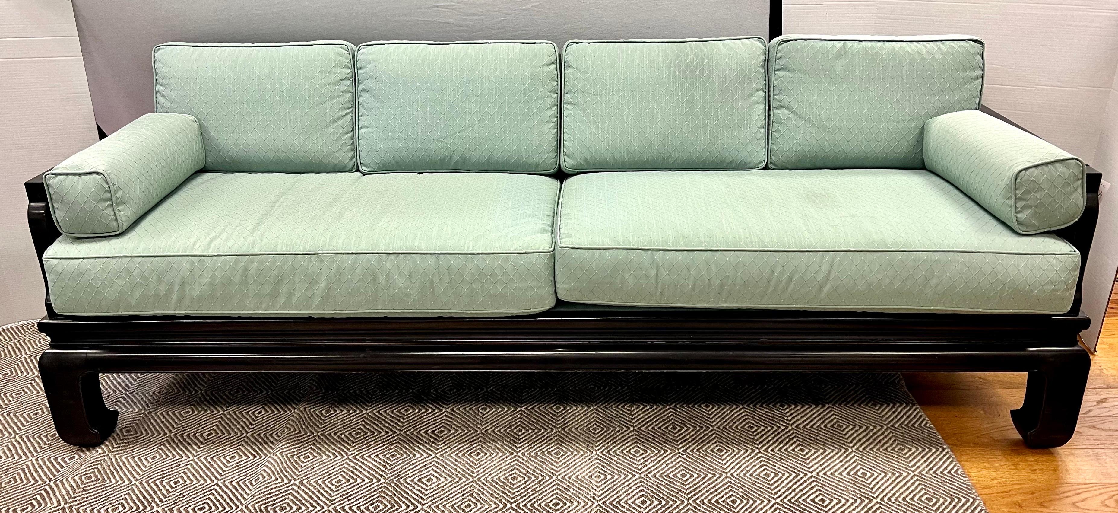 Elegant James Mont style chinoiserie sofa and matching loveseat set with ebonized black frames that are pierced, James Mont Style, throughout - see pics. They come with fitted blue-green upholstered cushions, each with flat crest and fretwork type