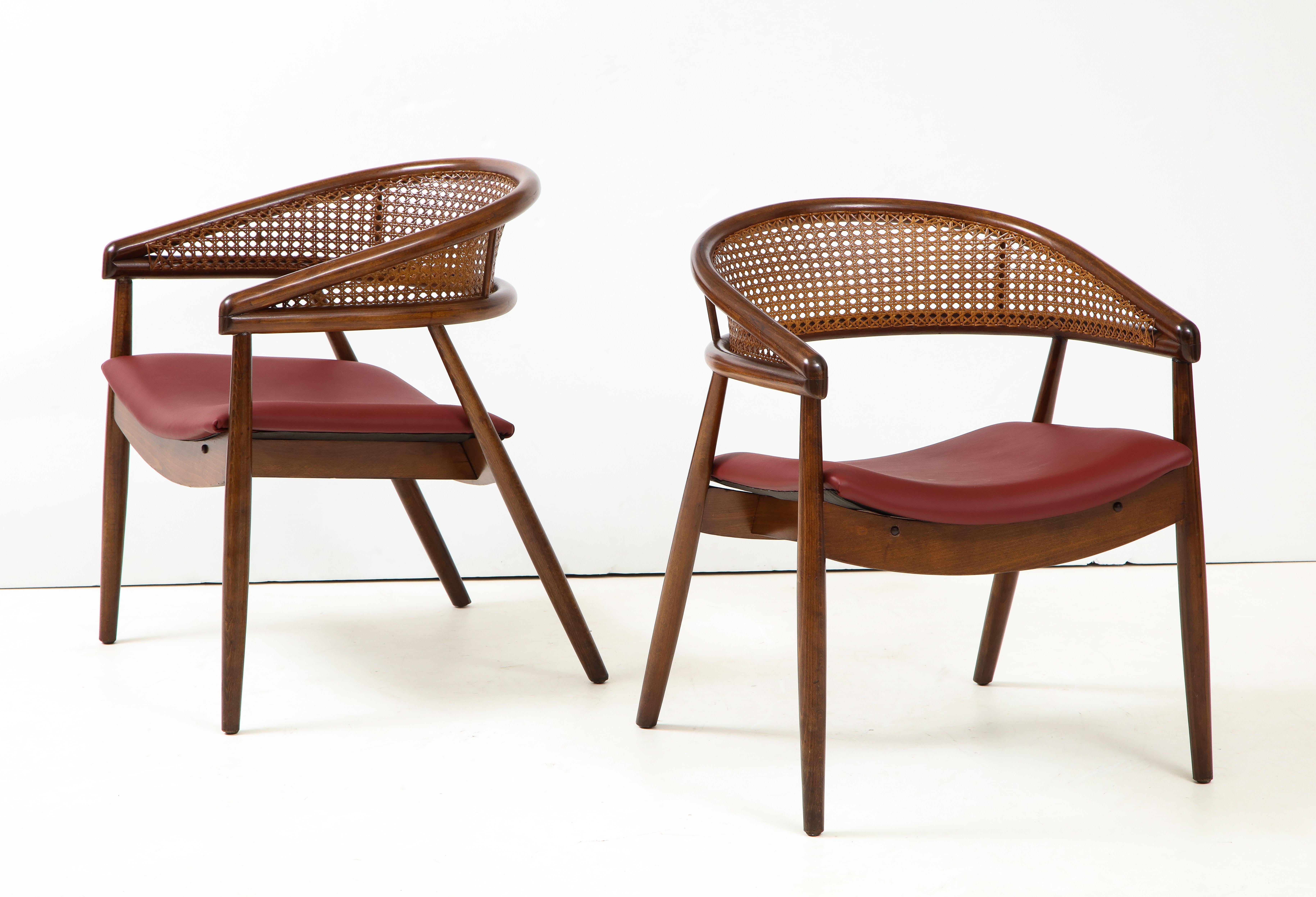 Stunning pair of 1960s James Mont style bent beech and cane armchairs with leather upholstery.
