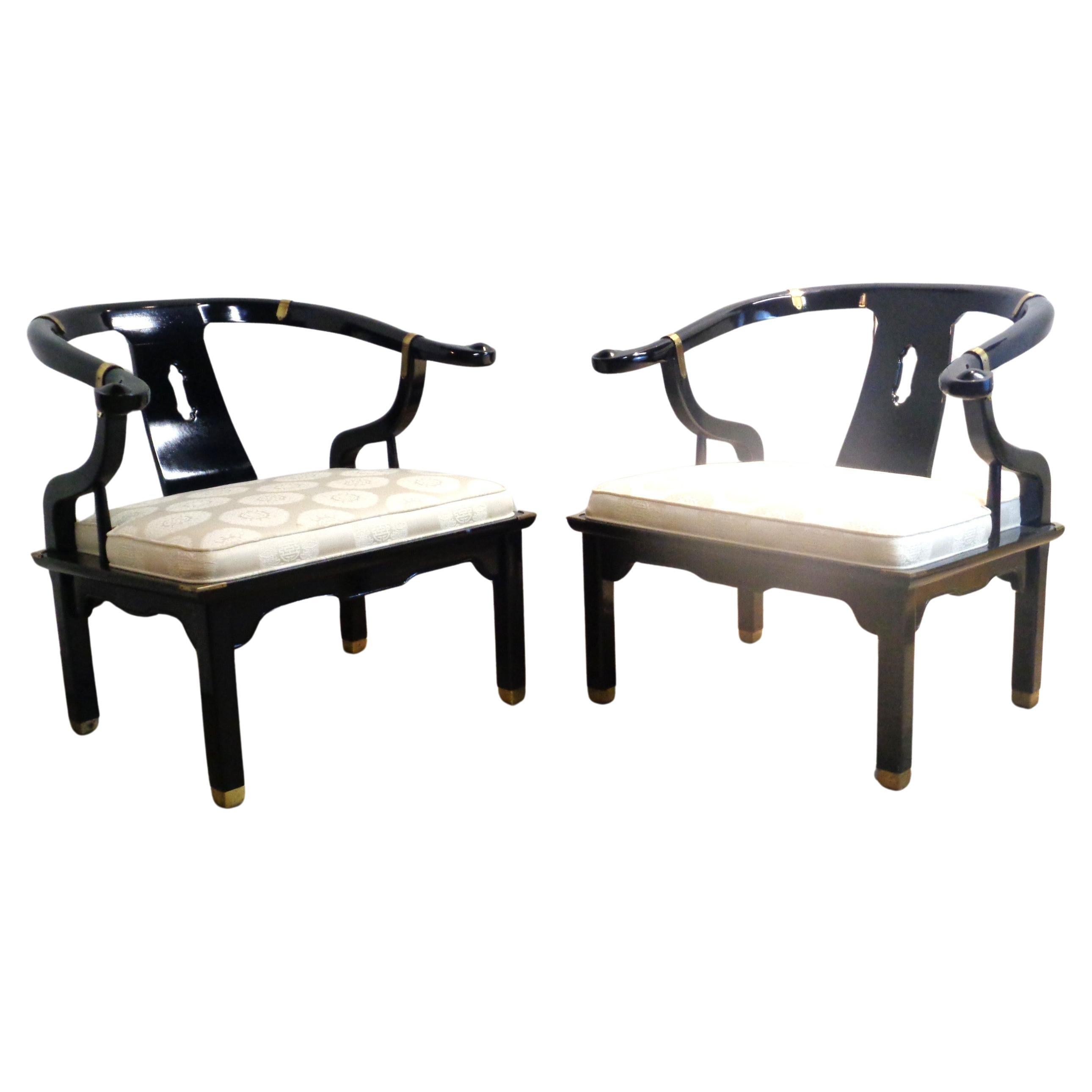 Pair of Asian modern black lacquered horseshoe back lounge chairs with brass fittings by Century Furniture Company.  All original beautiful glowing condition. Style of James Mont. Circa 1980. Measure 30