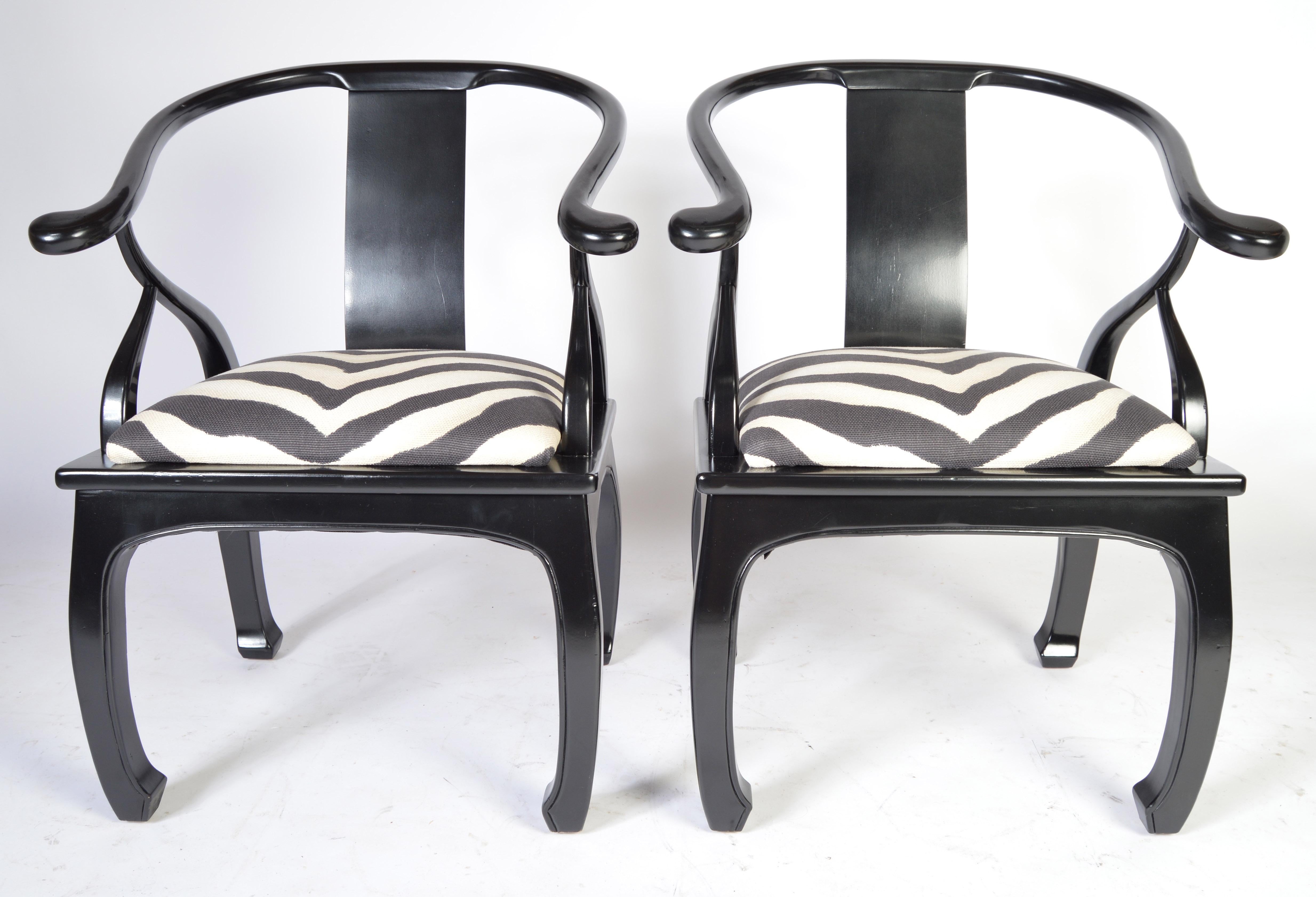 A stunning pair of midcentury Regency chinoiserie chairs in the manner of James Mont lacquered black having Ralph Lauren upholstery.