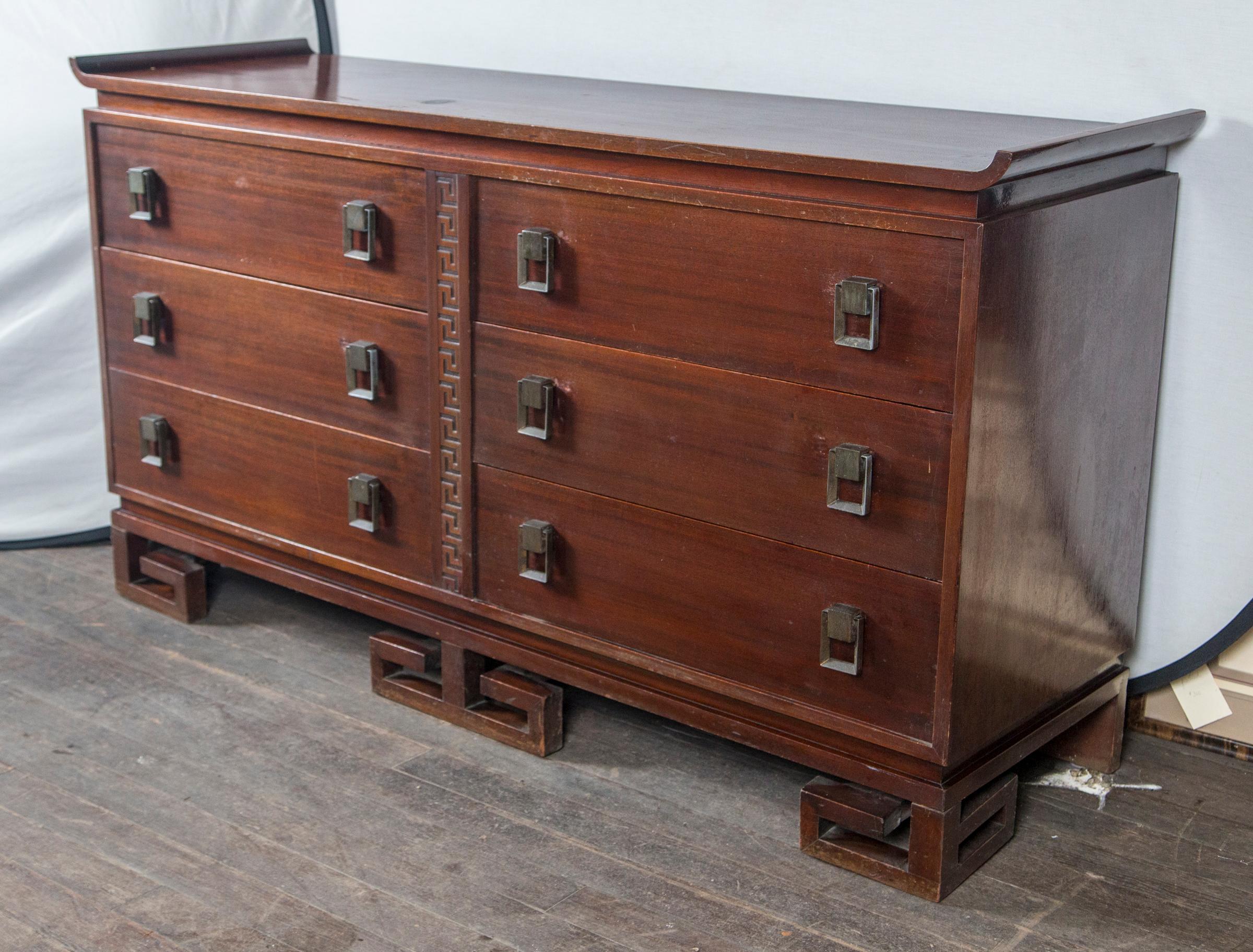 Dark wood six-drawer cabinet with Asian design. Stunning Greek key feet.