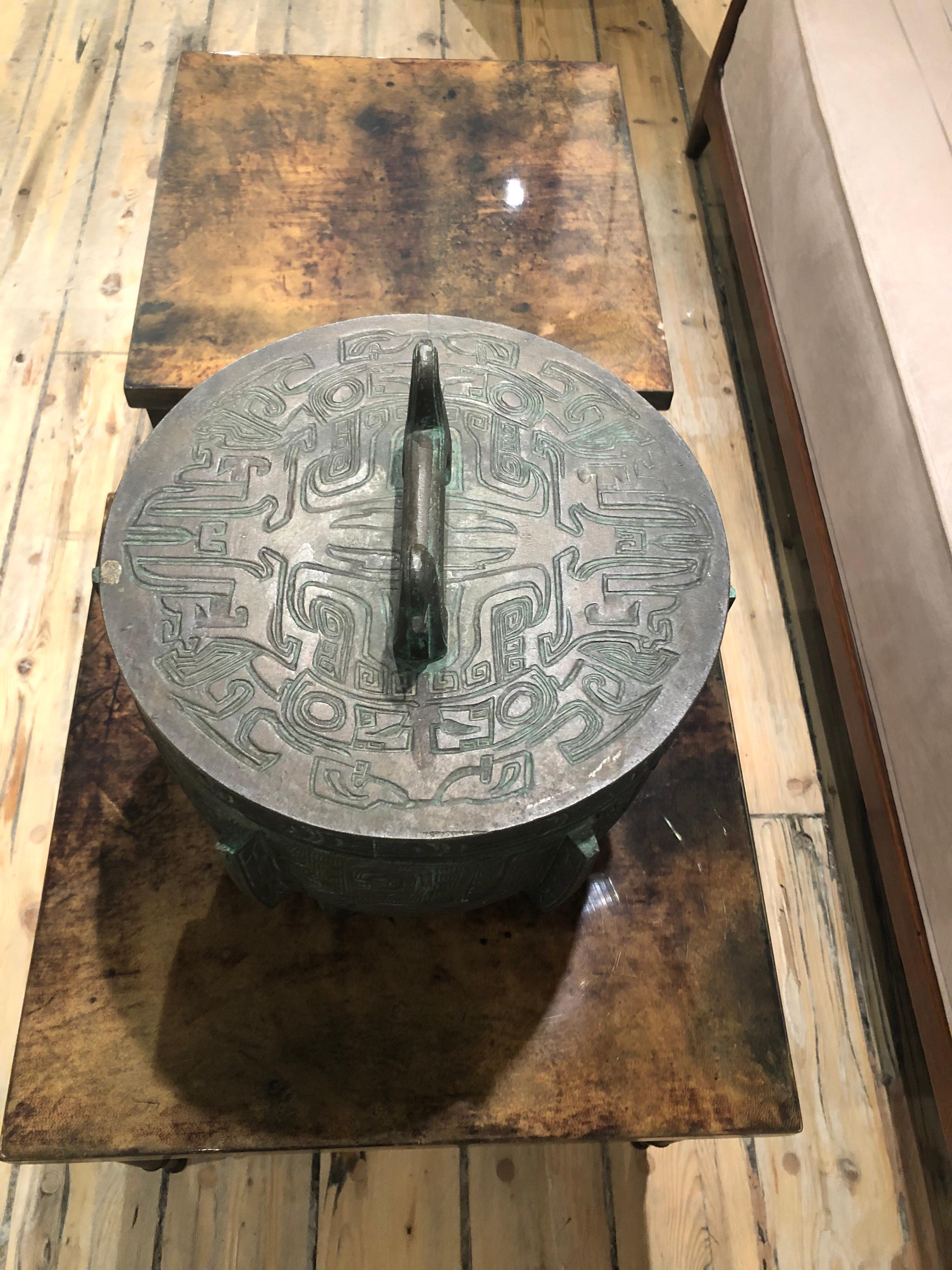 Heavy cast aluminum ice bucket in the style of a Chinese urn, patinated in bronze and insulated on the inside. Raised mark, made in Taiwan to the underside. Very whimsical, 1960s.