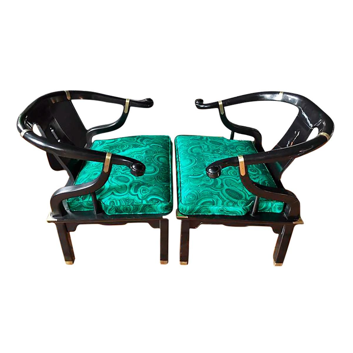 Pair of Hollywood Regency Century Furniture lounge accent armchairs in the style of James Mont. Black lacquered wood frames with brass accents. Cushions newly upholstered in malachite printed fabric by Tony Duquette. Original century label to bottom