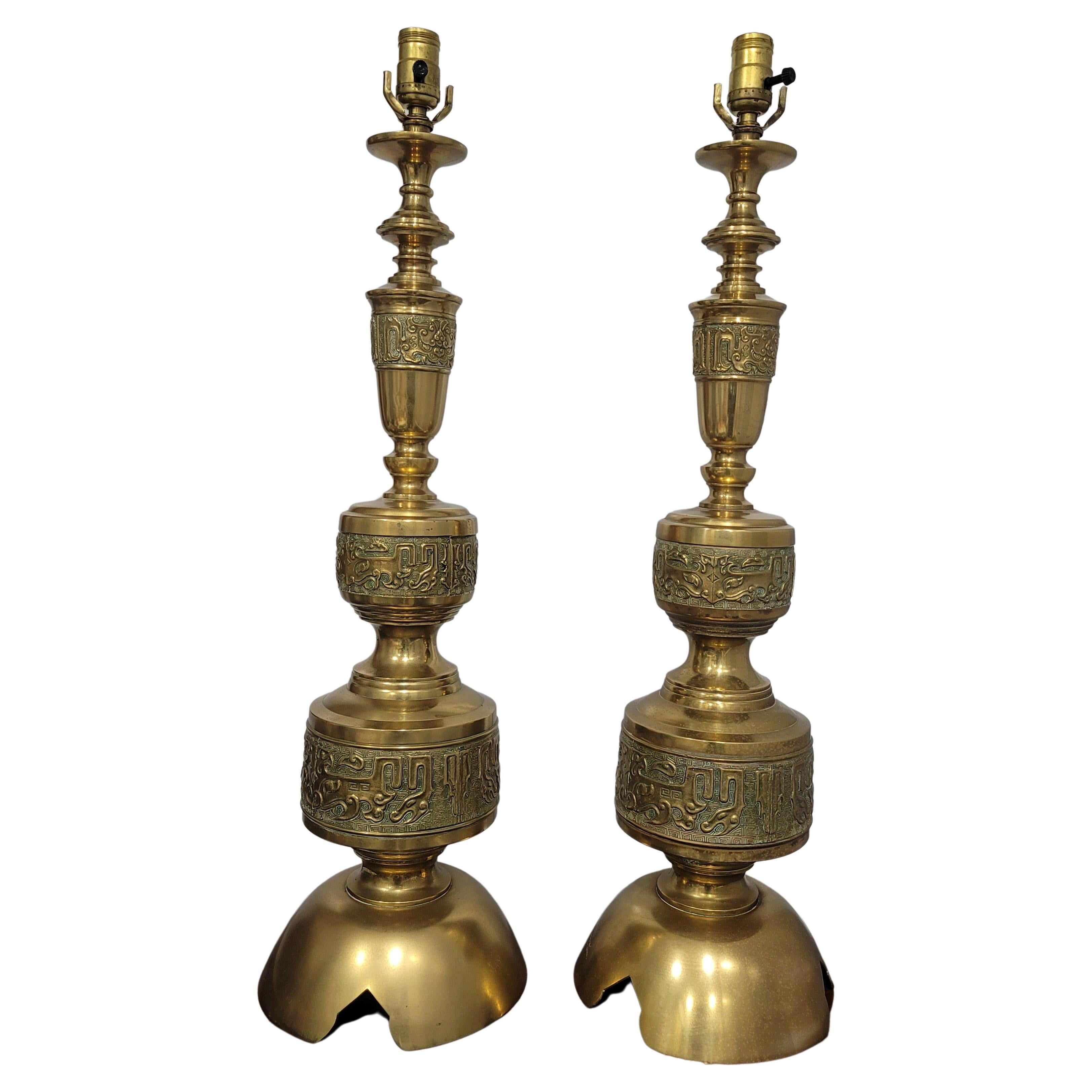 Very stylish cast brass table lamps with Asian feel. Tall and imposing with the great James Mont impressive style. 
 