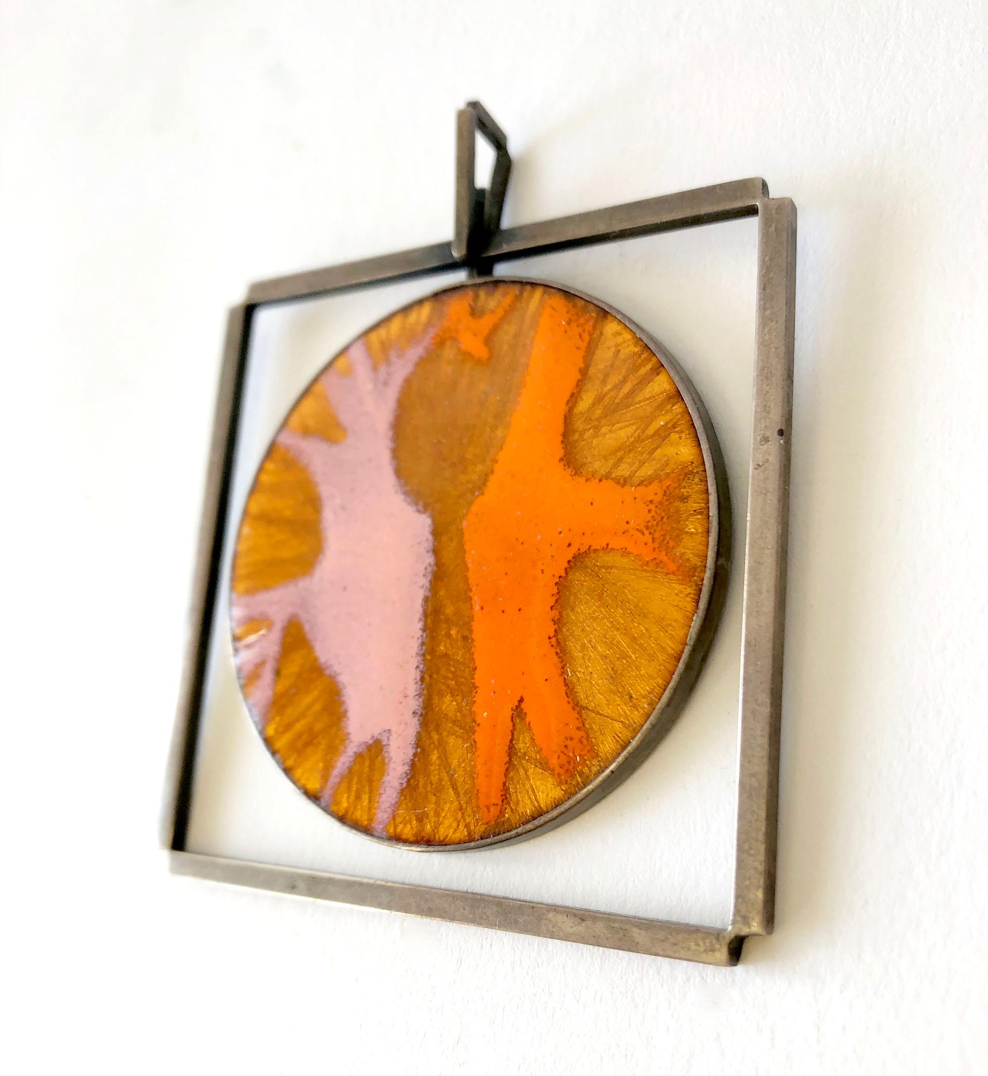 One of a kind sterling silver and orange and pink enamel kinetic modernist pendant created by James Parker of San Diego, California.  Pendant measures 3